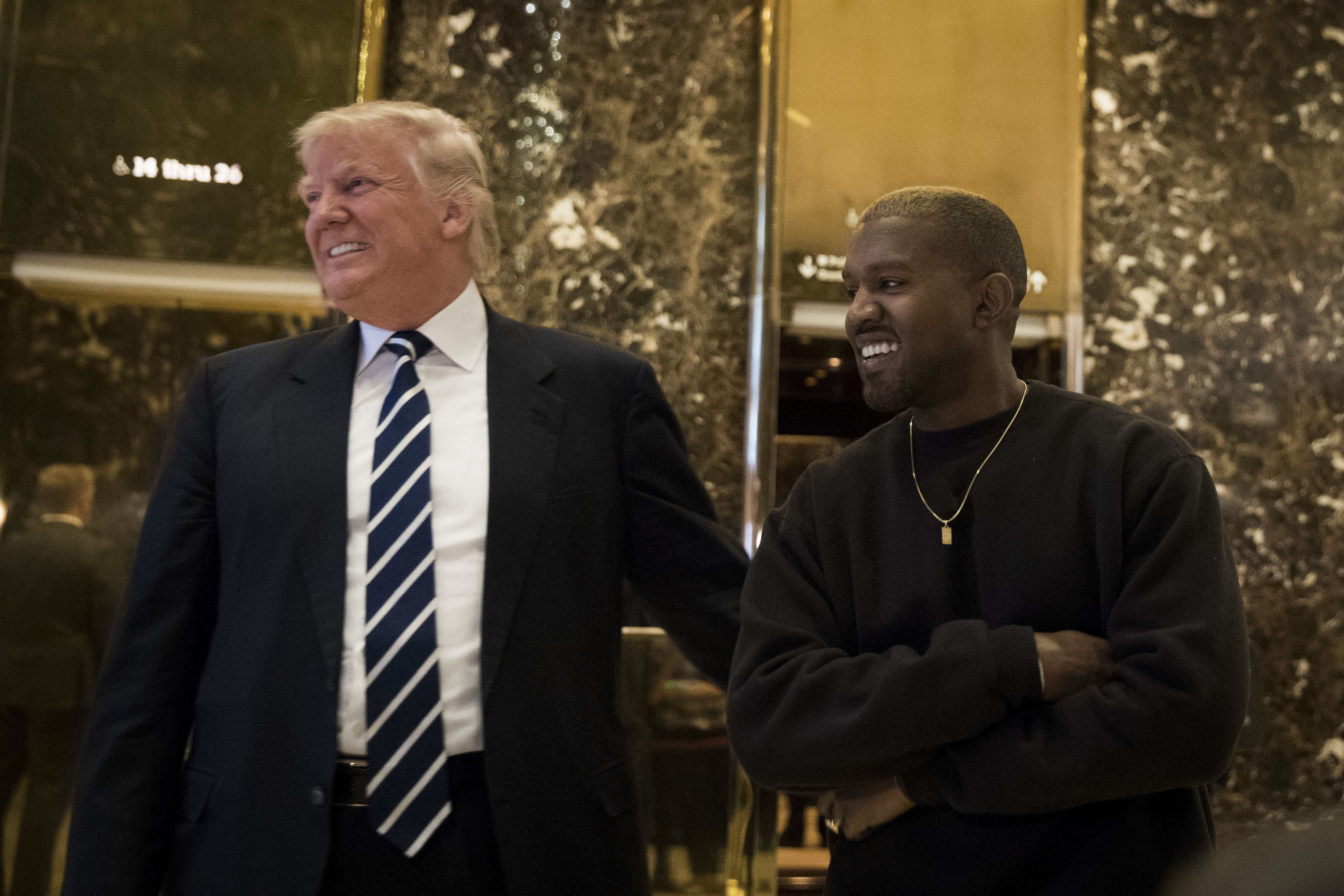 NEW YORK, NY - DECEMBER 13: (L to R) President-elect Donald Trump and Kanye West stand together in the lobby at Trump Tower. (Photo by Drew Angerer/Getty Images)