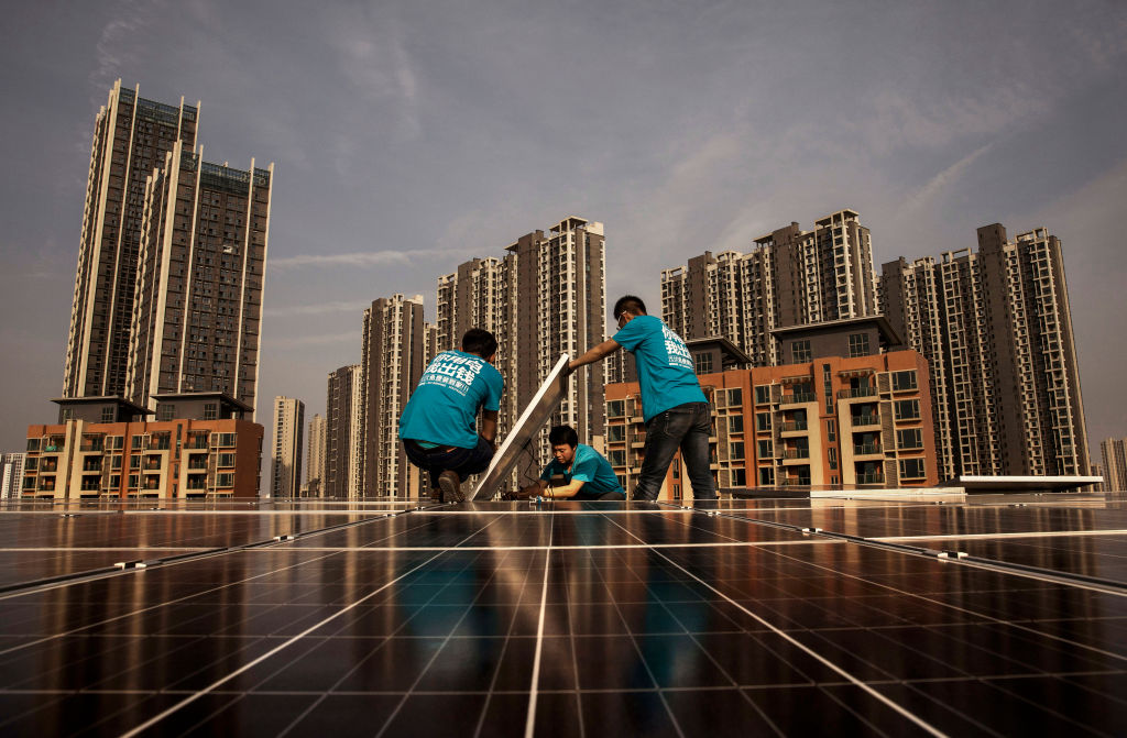 Chinese solar power workers in Wuhan, China on April 27, 2017. CREDIT: Kevin Frayer/Getty Images