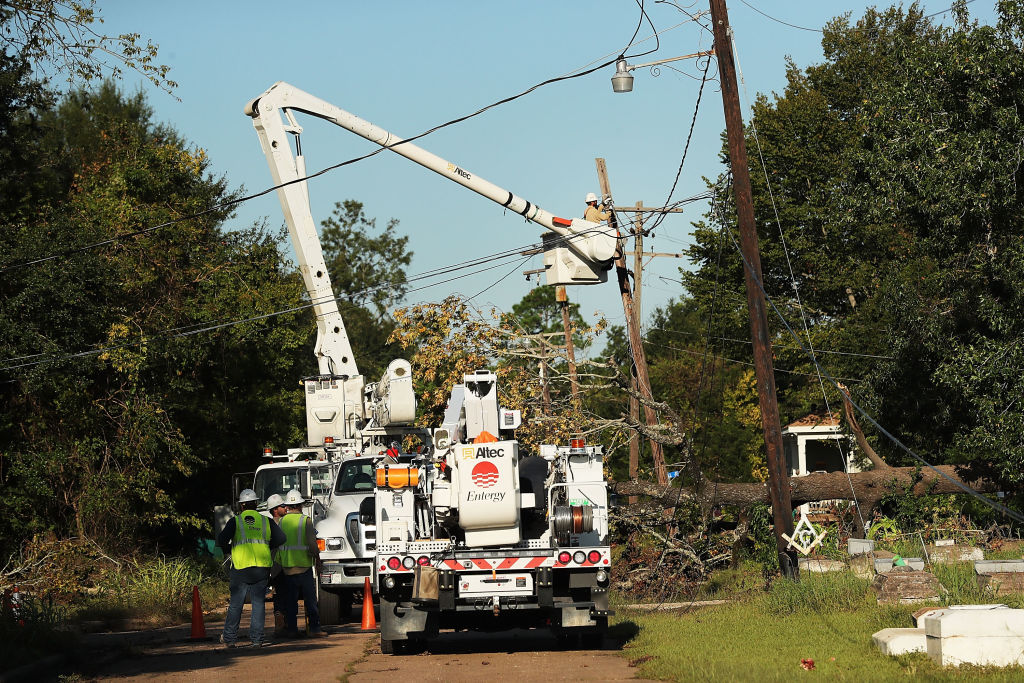 Workers repair wires in Orange, Texas after the devastation caused by Hurricane Harvey on September 7, 2017. CREDIT: Spencer Platt/Getty Images