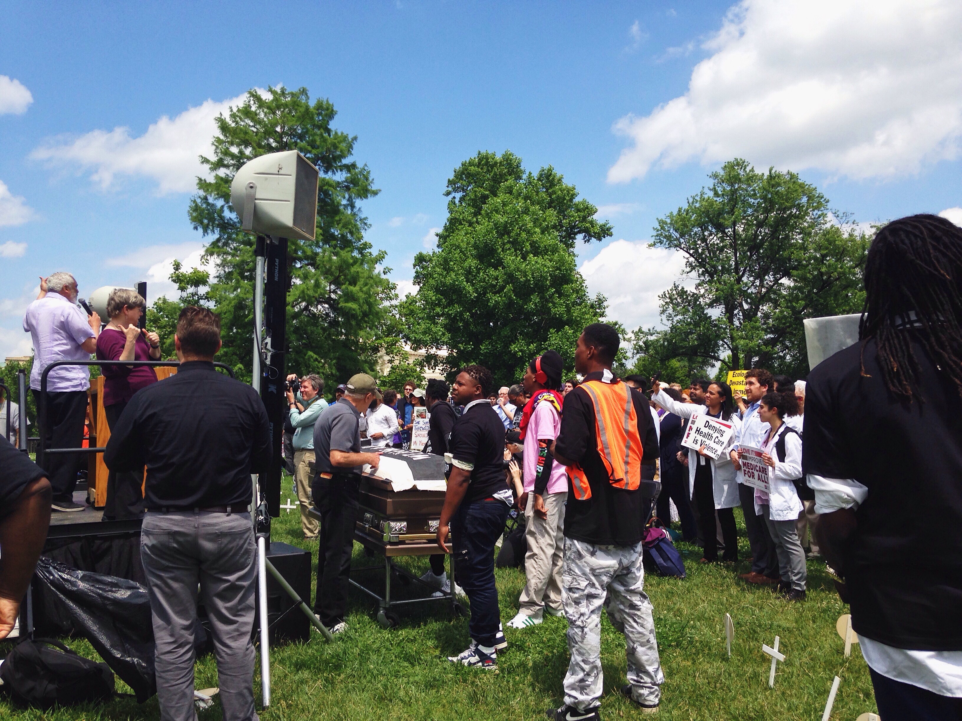 Volunteers take away a casket meant to symbolize the death toll issues like ecological devastation have caused. Activists were asked to remove the casket by police officers. CREDIT: E.A. Crunden