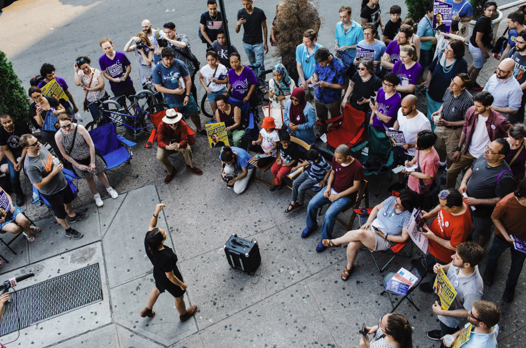 Ocasio-Cortez speaks to a crowd. Image via Twitter.
