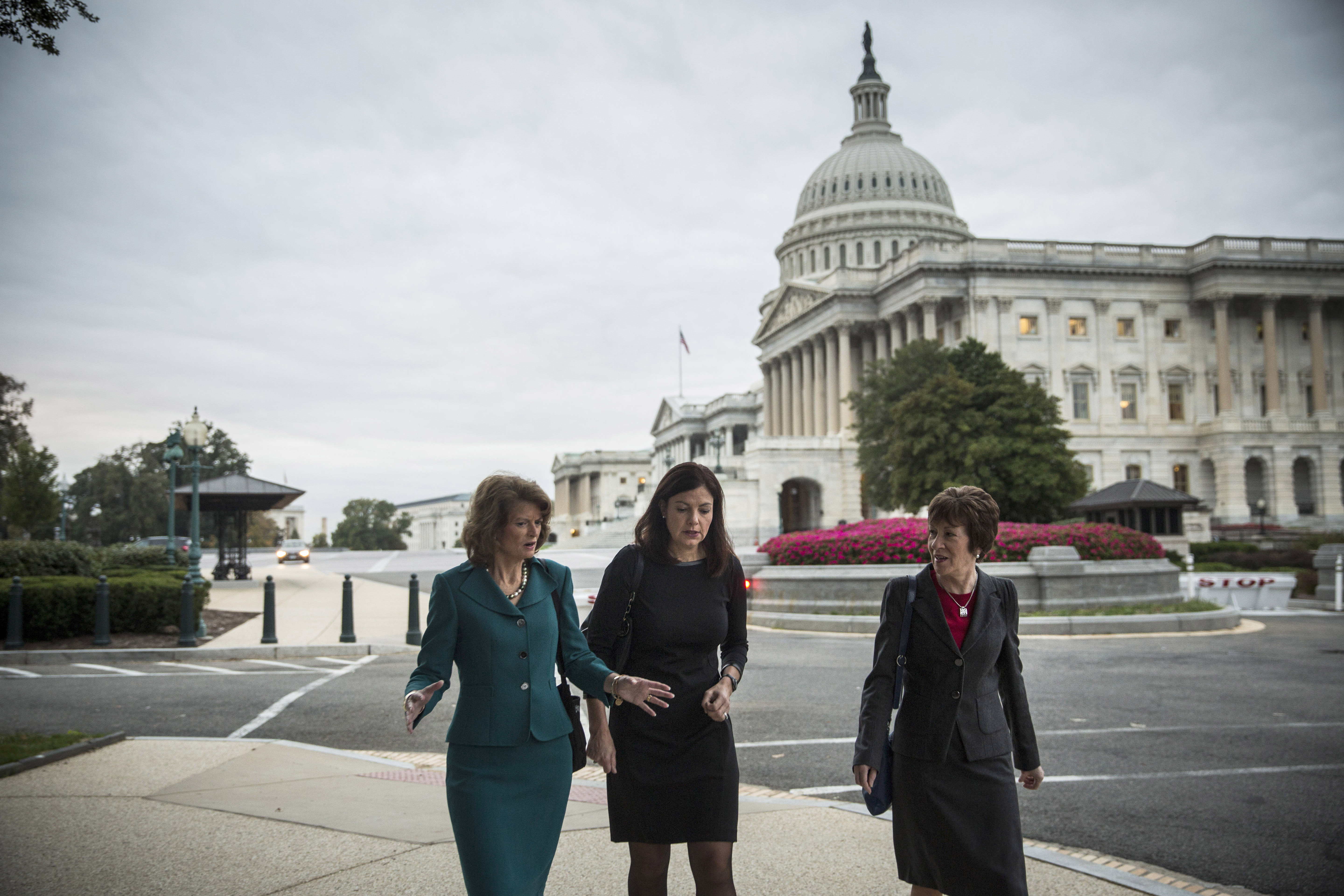 (L-R) Sen. Lisa Murkowski (R-AK), Sen. Kelly Ayotte (R-NH) and Sen. Susan Collins (R-ME) walk past the Capitol Building. CREDIT: Andrew Burton/Getty Images
