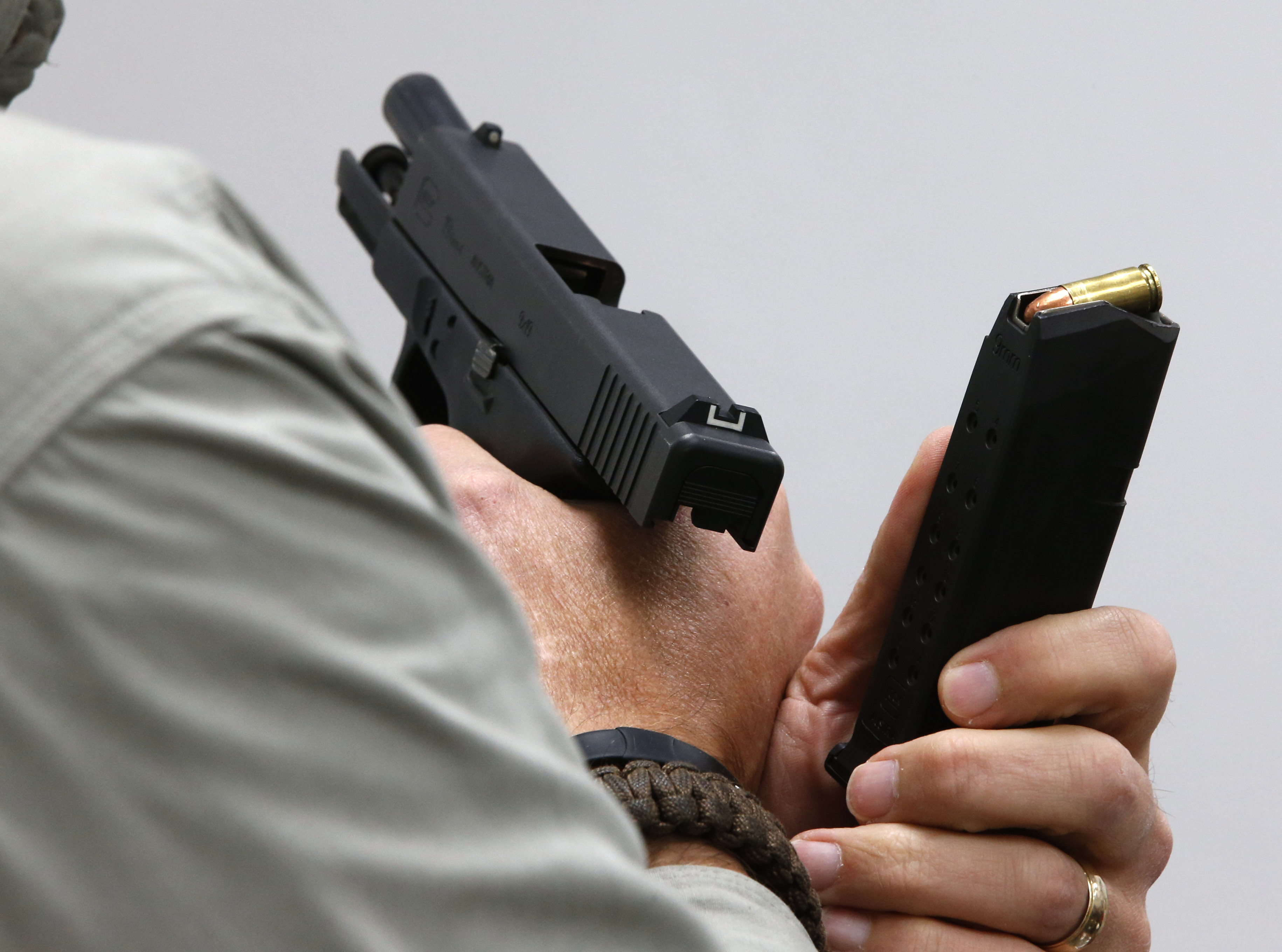 Gun instructor Mike Stilwell demonstrates how you can accidentally put a bullet in a magazine backwards during a concealed gun carry permit class at Range Master of Utah, in this January 9, 2016, file photo. CREDIT: George Frey/Getty Images