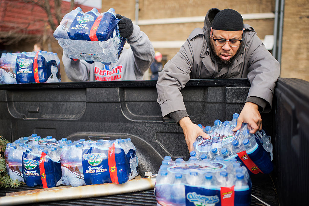 Volunteers load bottled water in a truck at the the Sylvester Broome Center in Flint, Mich. CREDIT: Tom Williams/CQ Roll Call