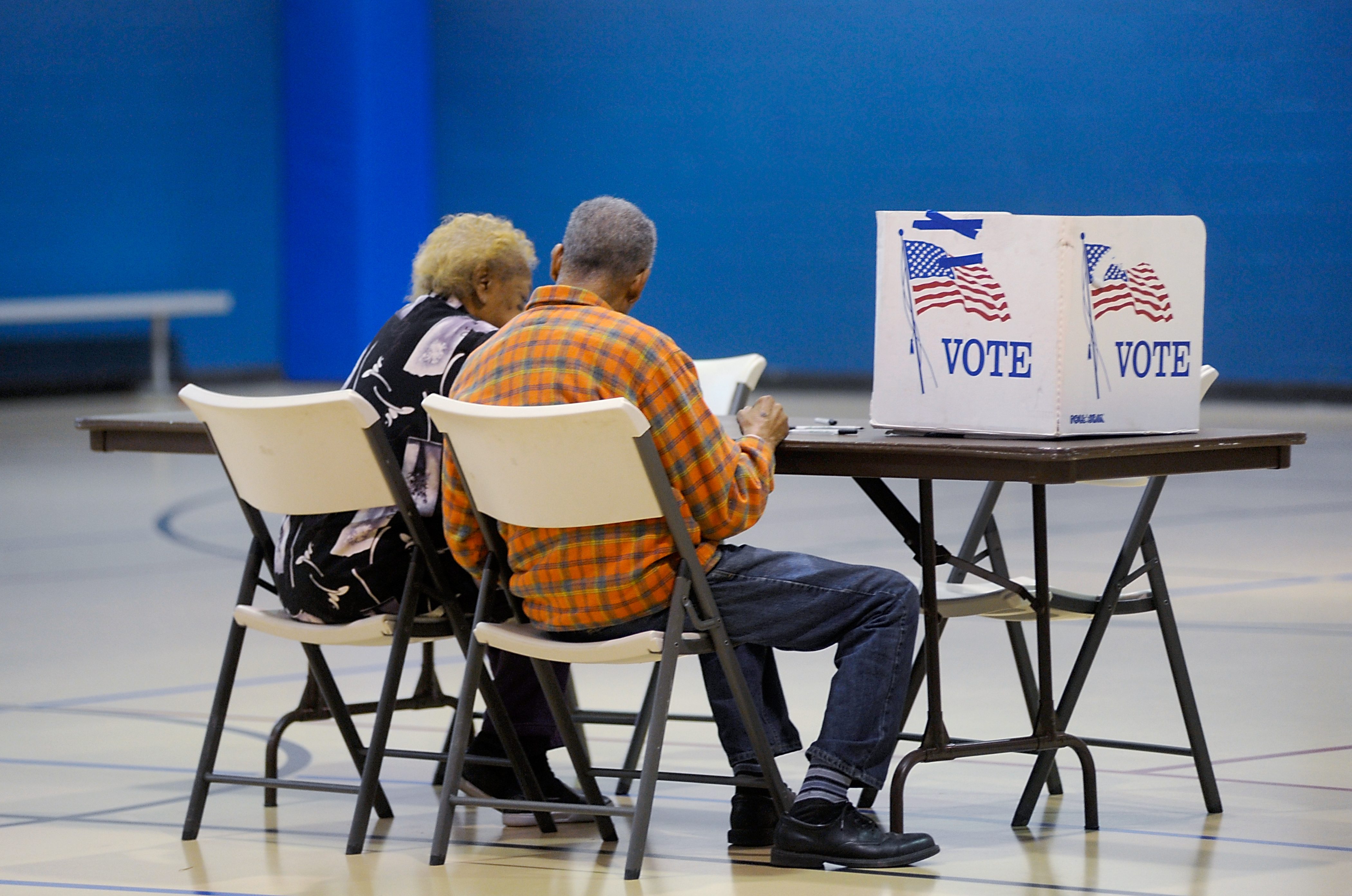 An elderly couple reads a ballot prior to voting on November 8, 2016 in Durham, North Carolina. CREDIT: Photo by Sara D. Davis/Getty Images