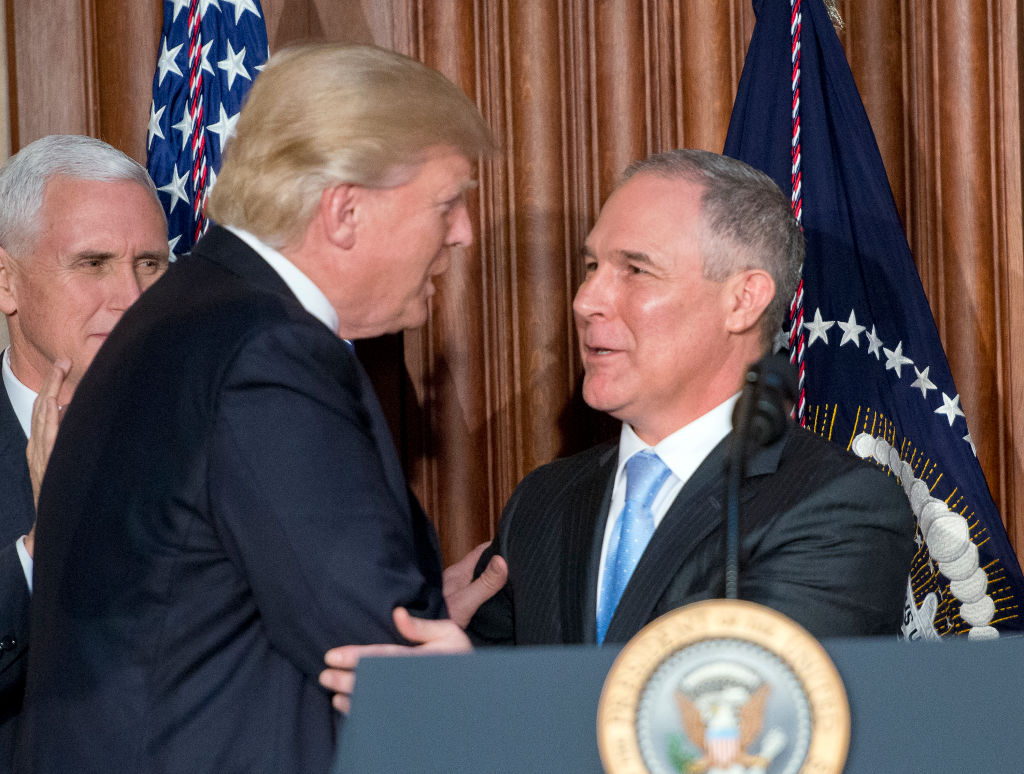 US President Donald Trump, left, is greeted by United States Environmental Protection Agency (EPA) Administrator Scott Pruitt, right. CREDIT: Ron Sach-Pool/Getty Images