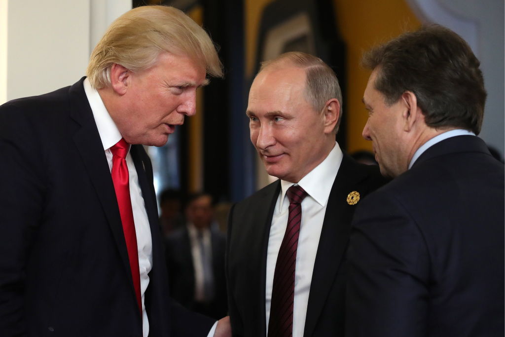 US president Donald Trump (L) and Russia's president Vladimir Putin (C) talk after a meeting on the closing day of the 25th APEC Summit. (CREDIT: Mikhail KlimentyevTASS via Getty Images)