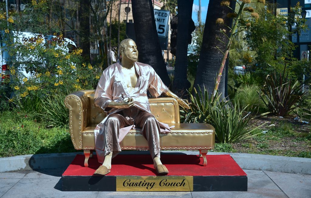 A gold sculpture of Harvey Weinstein on his infamous casting couch holding an Oscar statue is on display in Hollywood, California on March 1, 2018, where artists Plastic Jesus and Joshua Monroe displayed their creation days before the 90th Oscars Awards on Sunday, March 4. CREDIT: FREDERIC J. BROWN/AFP/Getty Images