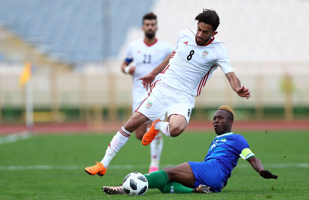 Ali Gholiadeh skips through a tackle in Nike boots during a friendly match against Sierra Leone at Tehran's Azadi Stadium in March. CREDIT: Amin M. Jamali/Getty Images