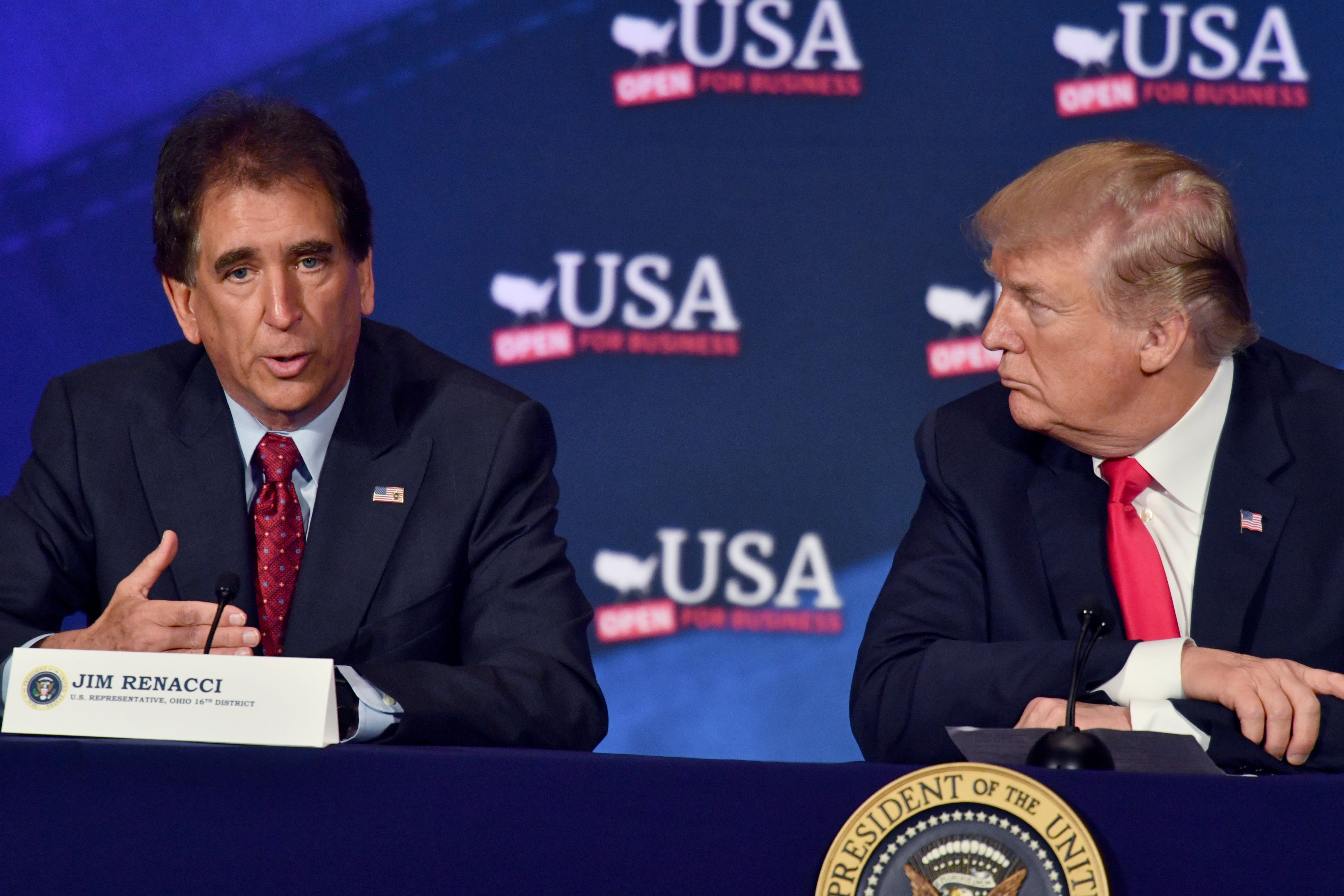 US President Donald Trump listens to US Representative Jim Renacci (L) during a roundtable discussion on the new tax law at the Cleveland Public Auditorium and Conference Center on May 5, 2018, in Cleveland, Ohio. CREDIT: Photo credit should read NICHOLAS KAMM/AFP/Getty Images