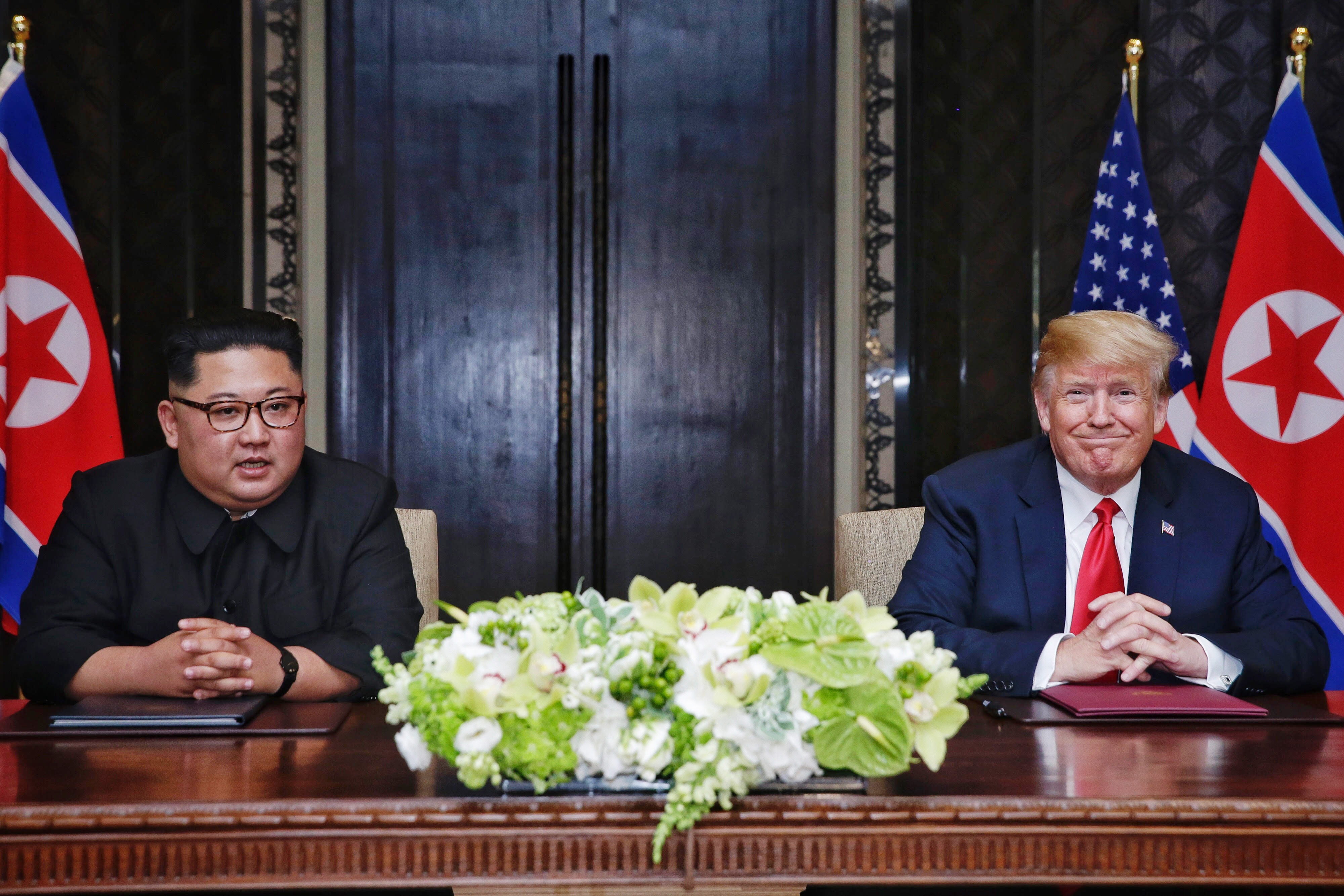 North Korean leader Kim Jong-un (L) with U.S. President Donald Trump (R) during their historic U.S.-DPRK summit at the Capella Hotel on Sentosa island on June 12, 2018 in Singapore. CREDIT: Kevin Lim/The Strait Times/Handout/Getty Images