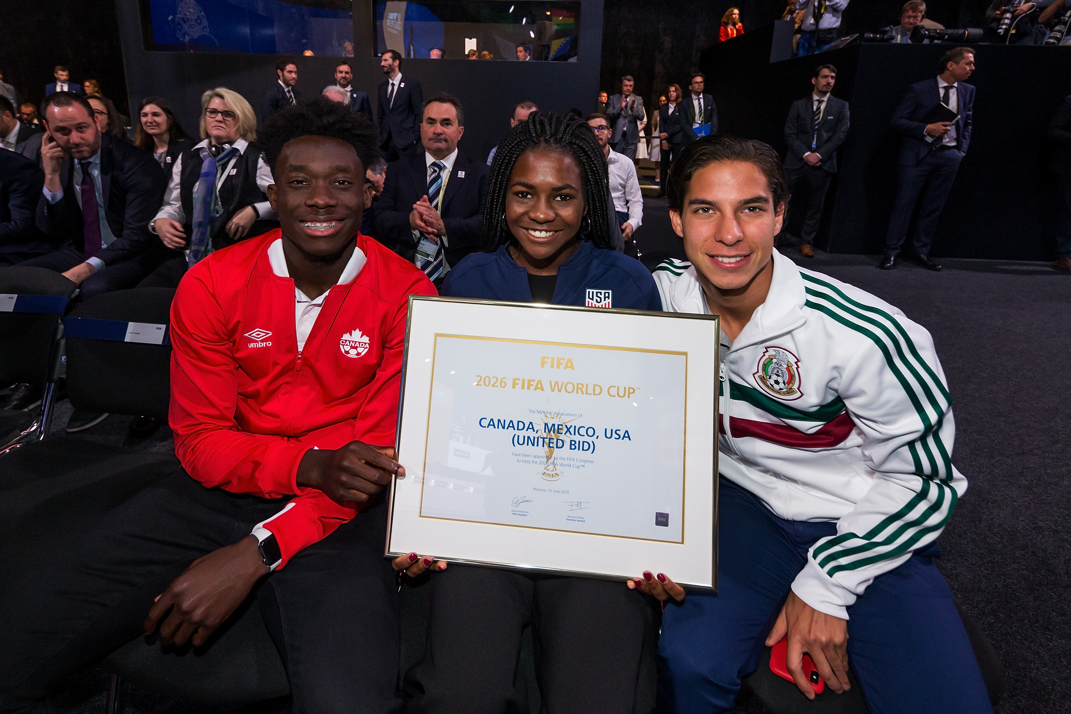 MOSCOW, RUSSIA - JUNE 13: Alphonso Davies, Brianna Pinto and Diego Lainez pose after the announcement, that the 2026 FIFA World Cup will be held in the United States, Mexico and Canada during the 68th FIFA Congress at Expotsentr on June 13, 2018 in Moscow, Russia. (Photo by Joosep Martinson - FIFA/FIFA via Getty Images)