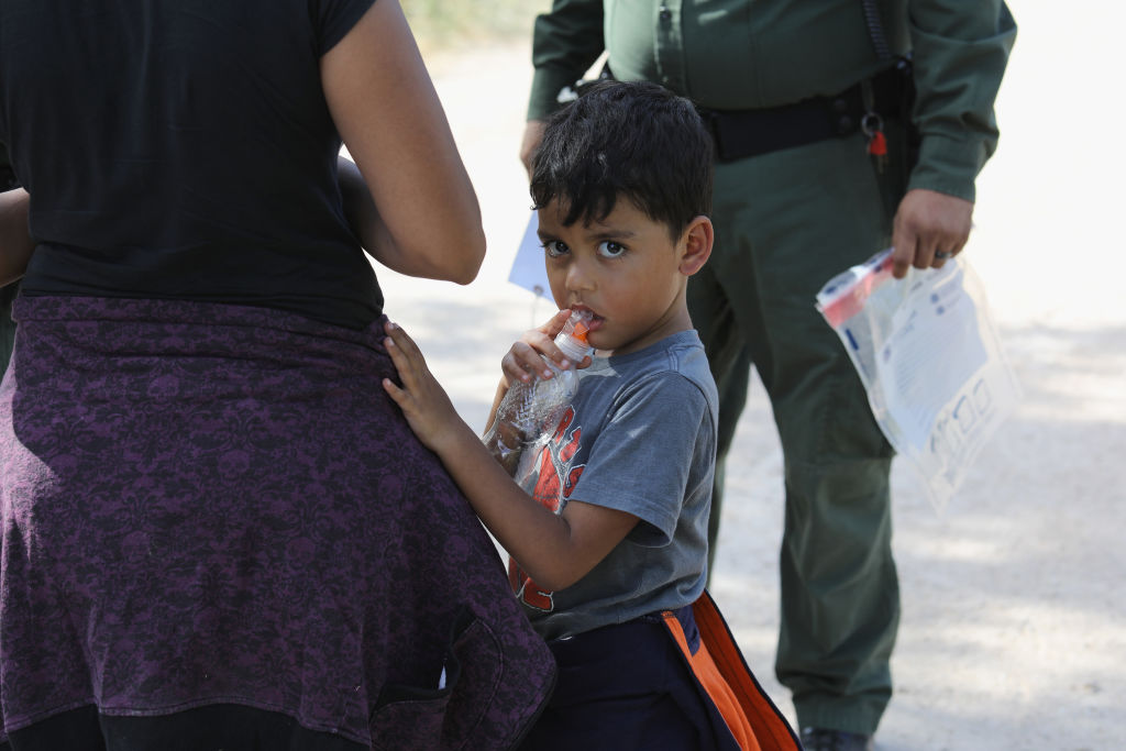 Central American asylum seekers wait as U.S. Border Patrol agents take them into custody on June 12, 2018 near McAllen, Texas. (Photo by John Moore/Getty Images)