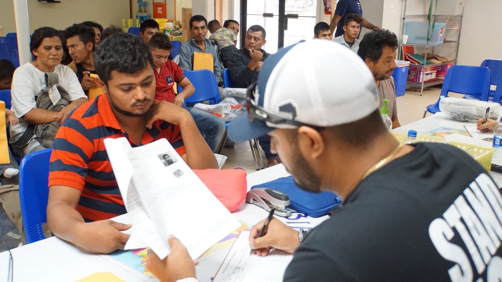 A migrant is registered at a humanitarian center in the border town of McAllen, Texas on June 14, 2018. CREDIT: Leila Macor / AFP