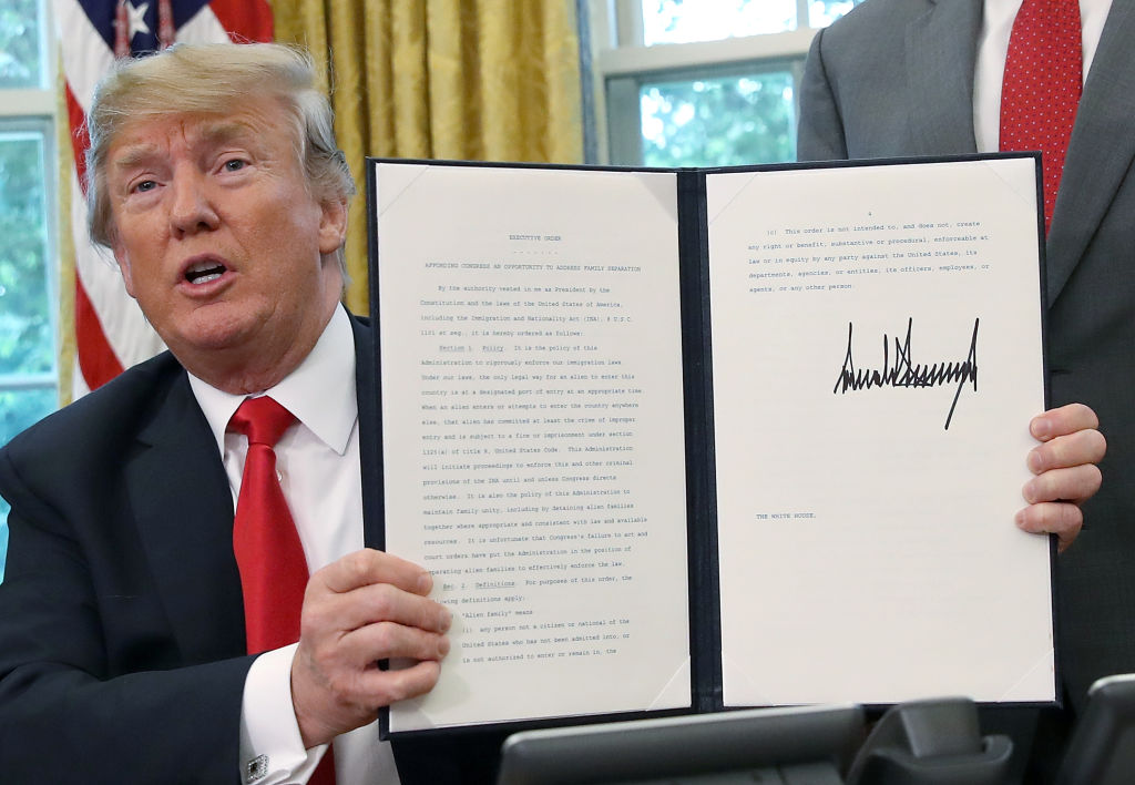 President Donald Trump displays his immigration order. CREDIT: Win McNamee/Getty Images