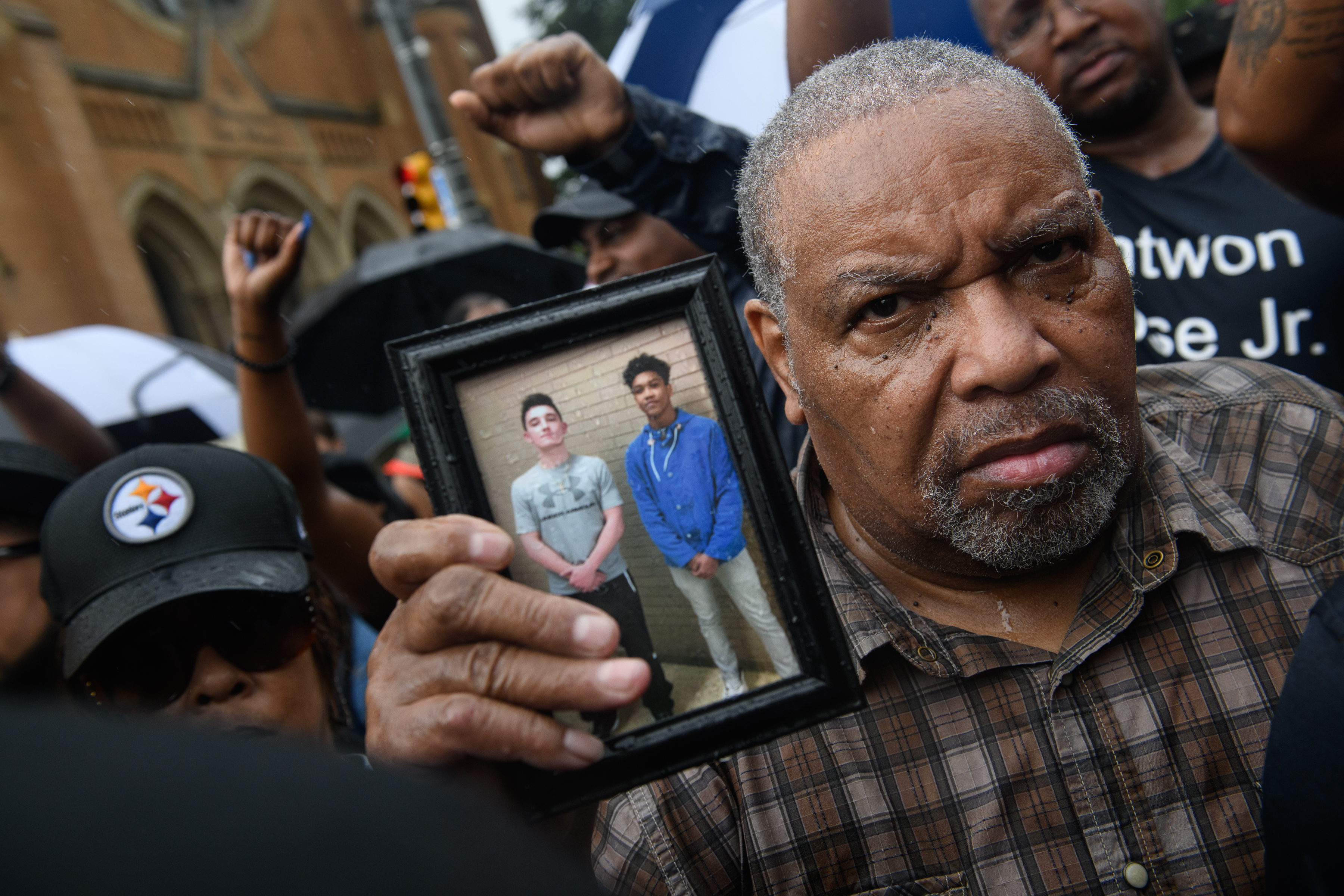 A man holds a photo of Antwon Rose as he joins a protest Saturday for the 17-year old, who was fatally shot by police in the back after a traffic stop. (CREDIT: Justin Merriman/Getty Images)