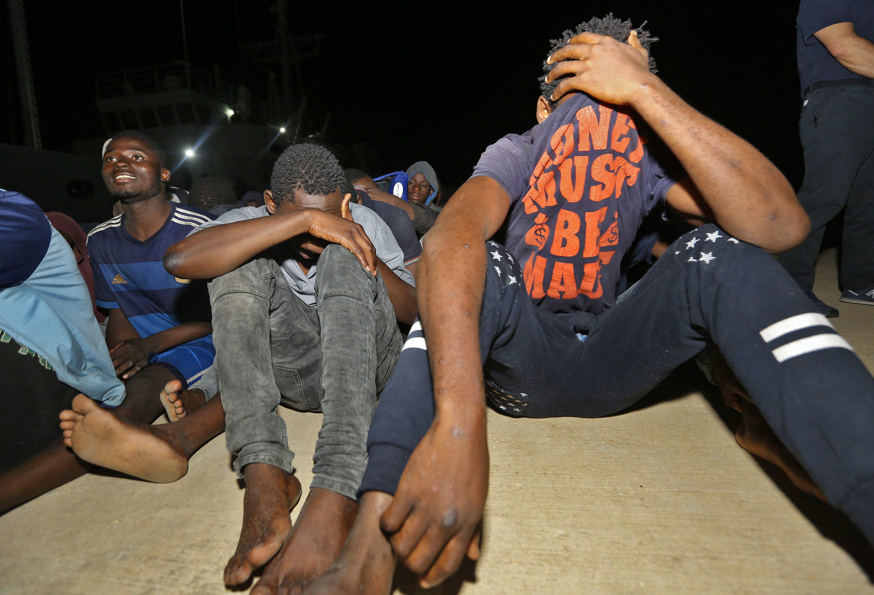 Migrants wait at a naval base in Tripoli, after being rescued in the Mediterranean on June 24, 2018. (CREDIT: Mahmud Turkia/AFP/Getty Images)
