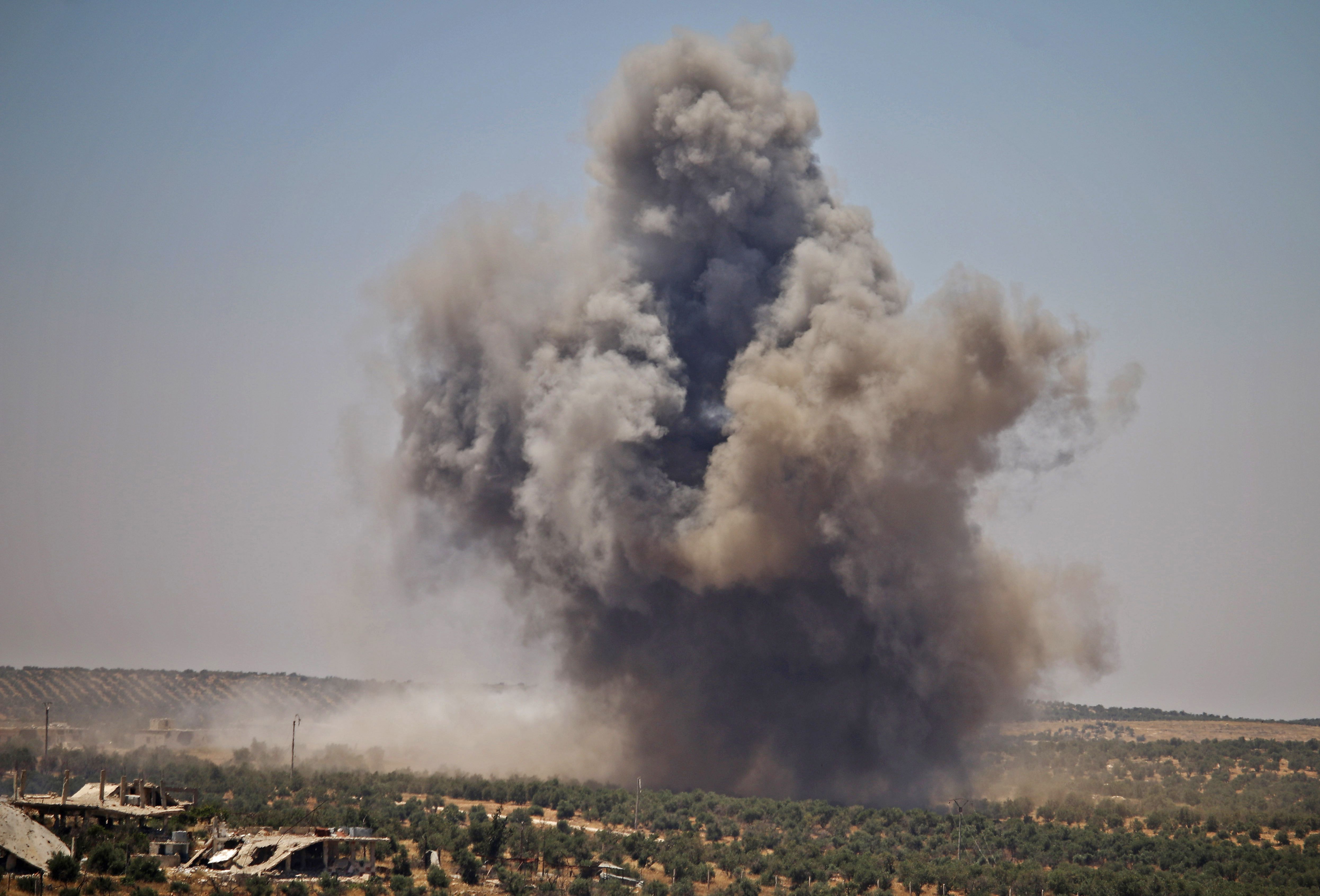 Smoke rises above opposition held areas of Daraa during airstrikes by Syrian regime forces on June 26, 2018. - Russian-backed regime forces have for weeks been preparing an offensive to retake Syria's south, a strategic zone that borders both Jordan and the Israeli-occupied Golan Heights. CREDIT: Mohamad Abazeed/AFP/Getty Images.