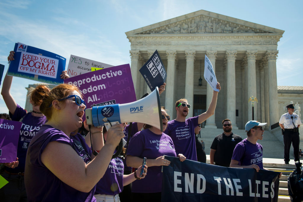 Protesters demonstrate outside the Supreme Court before the justices hand down their decision on crisis pregnancy centers. (CQ-Roll Call Group via Getty Images)