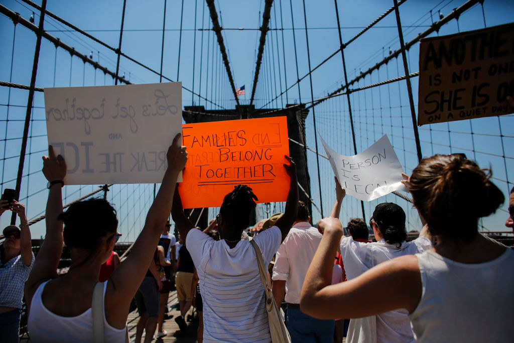 NEW YORK, NY - JUNE 30: People take part in the nationwide "Families Belong Together" march as they walk over the Brooklyn Bridge on June 30, 2018 in New York City. As thousands of migrant children remain separated from family, rallies are planned across the U.S. calling for them be reunited. (Photo by Kena Betancur/Getty Images)