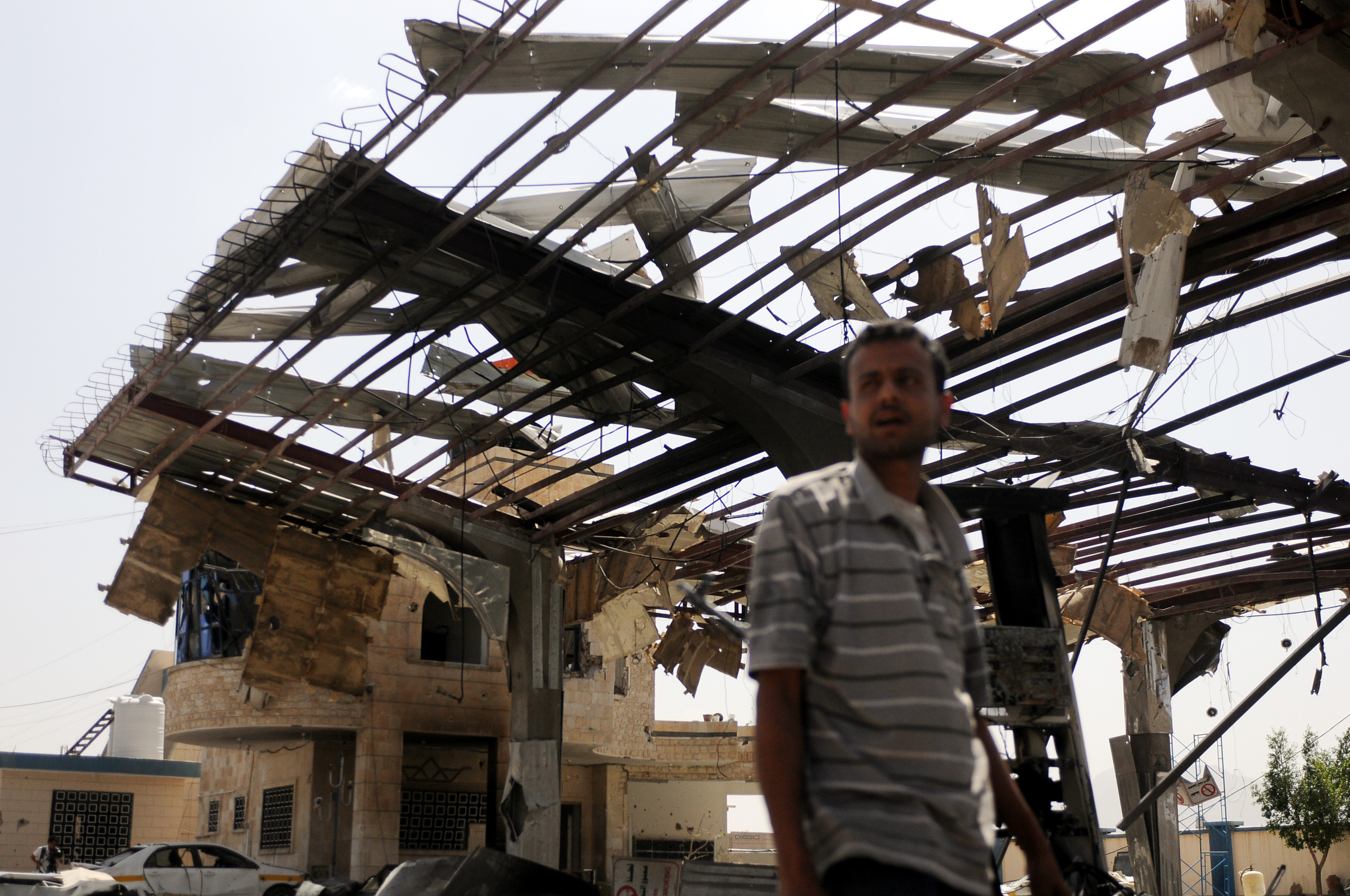 A man inspects a petrol station in Sana'a after it was hit by airstrikes carried out by war-planes of the Saudi-led coalition on May 27, 2018. The airstrikes killed at least five people and injuring 11 others. CREDIT: Mohammed Hamoud/Getty Images.