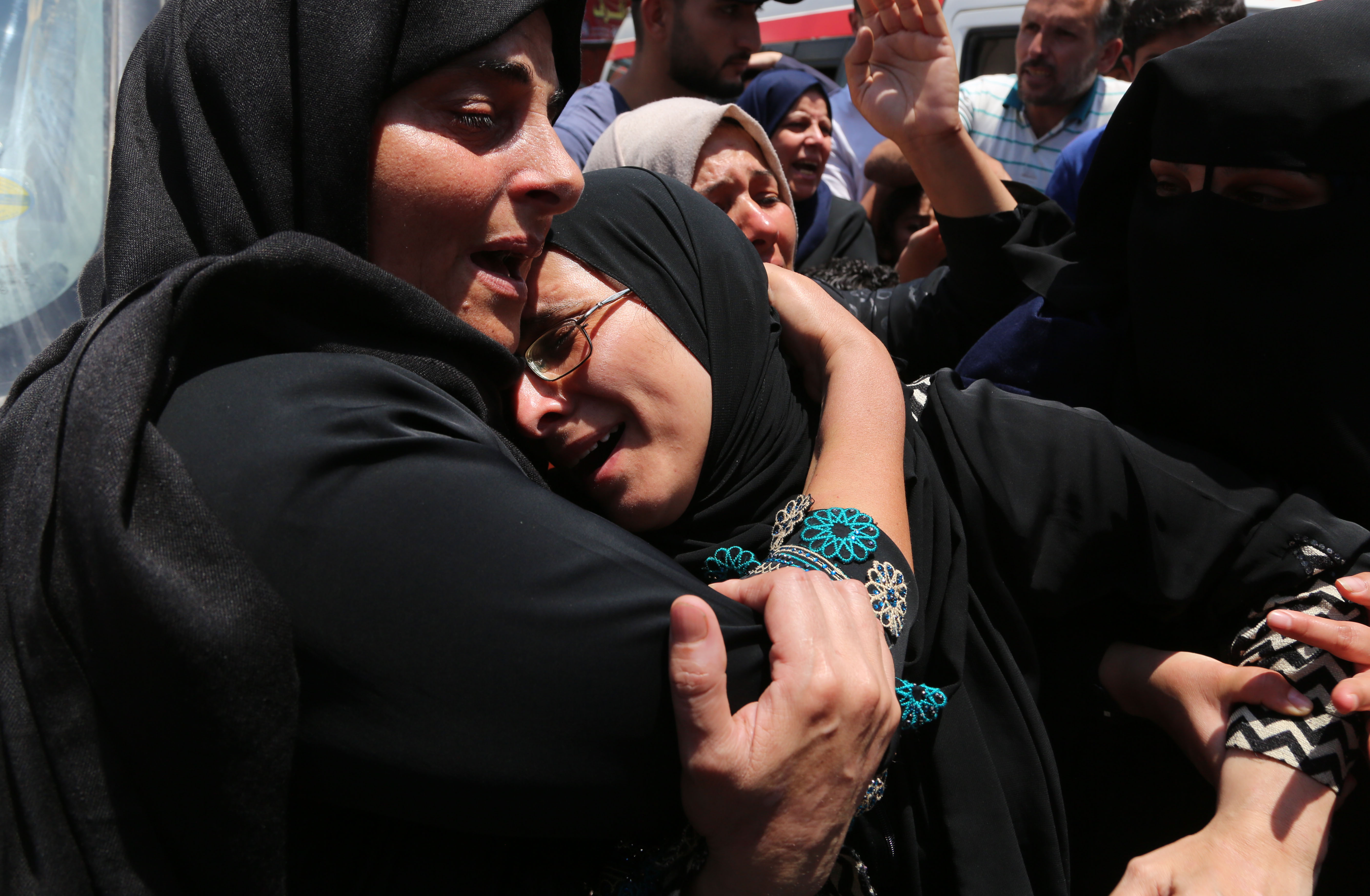 The mother of 21-year-old Razan al-Najjar mourns during her funeral. CREDIT: Momen Faiz/NurPhoto via Getty Images