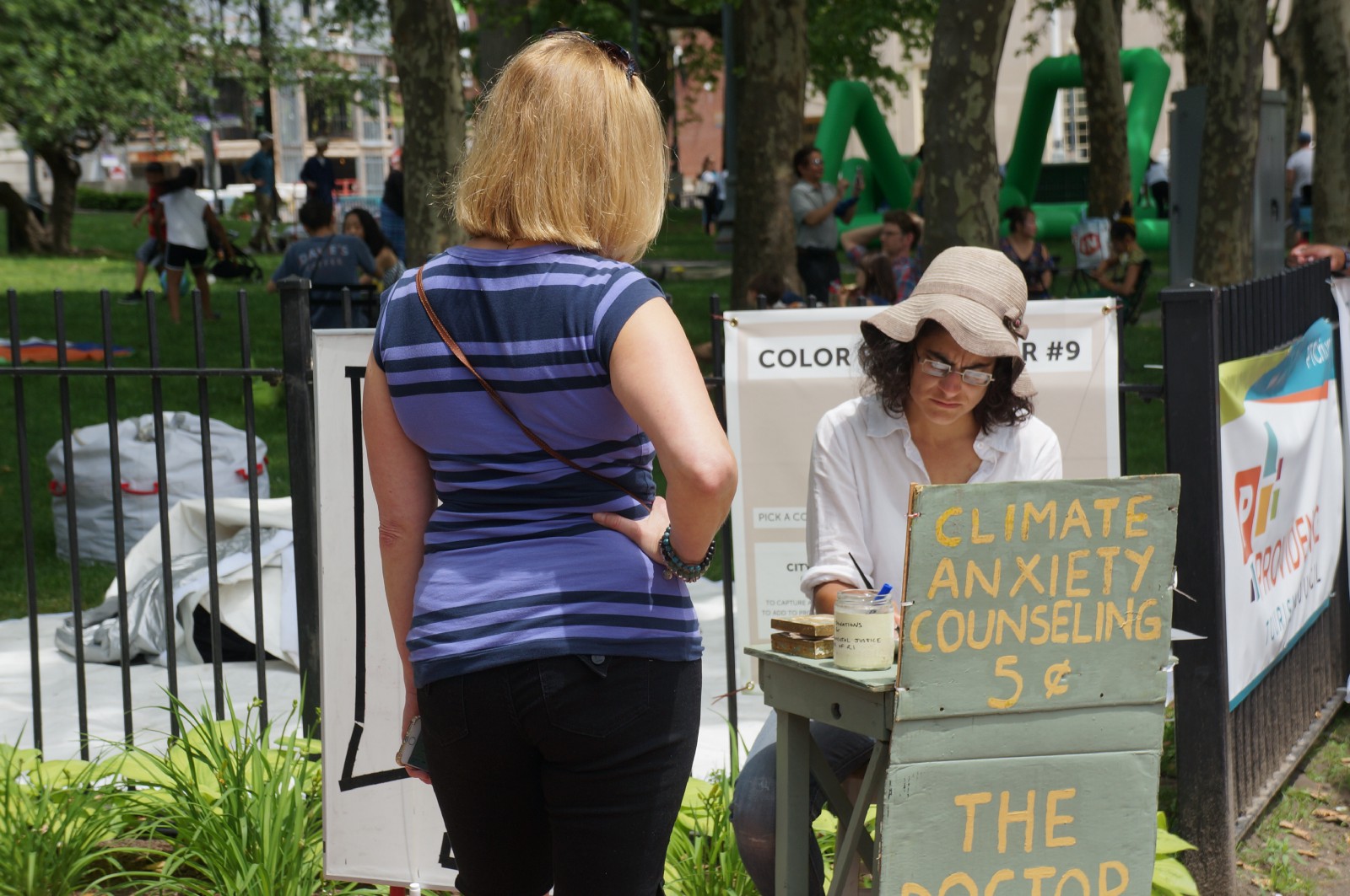 Kate Schapira speaks with a visitor to her booth. CREDIT: James Kuo