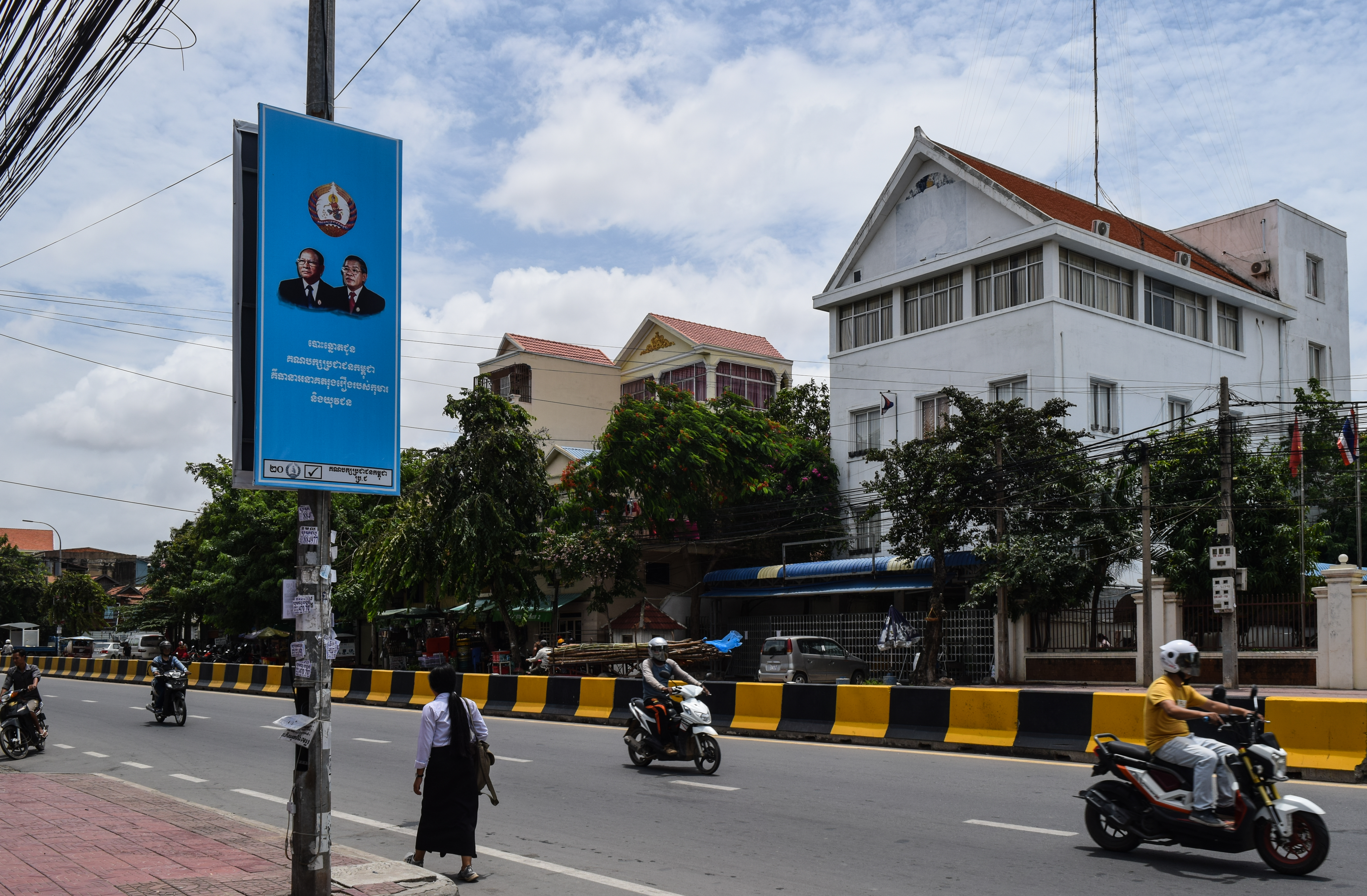 A CPP banner outside the former CNRP headquarters, where the logo was painted over after the party was dissolved. (Credit: Peter Ford for ThinkProgress)