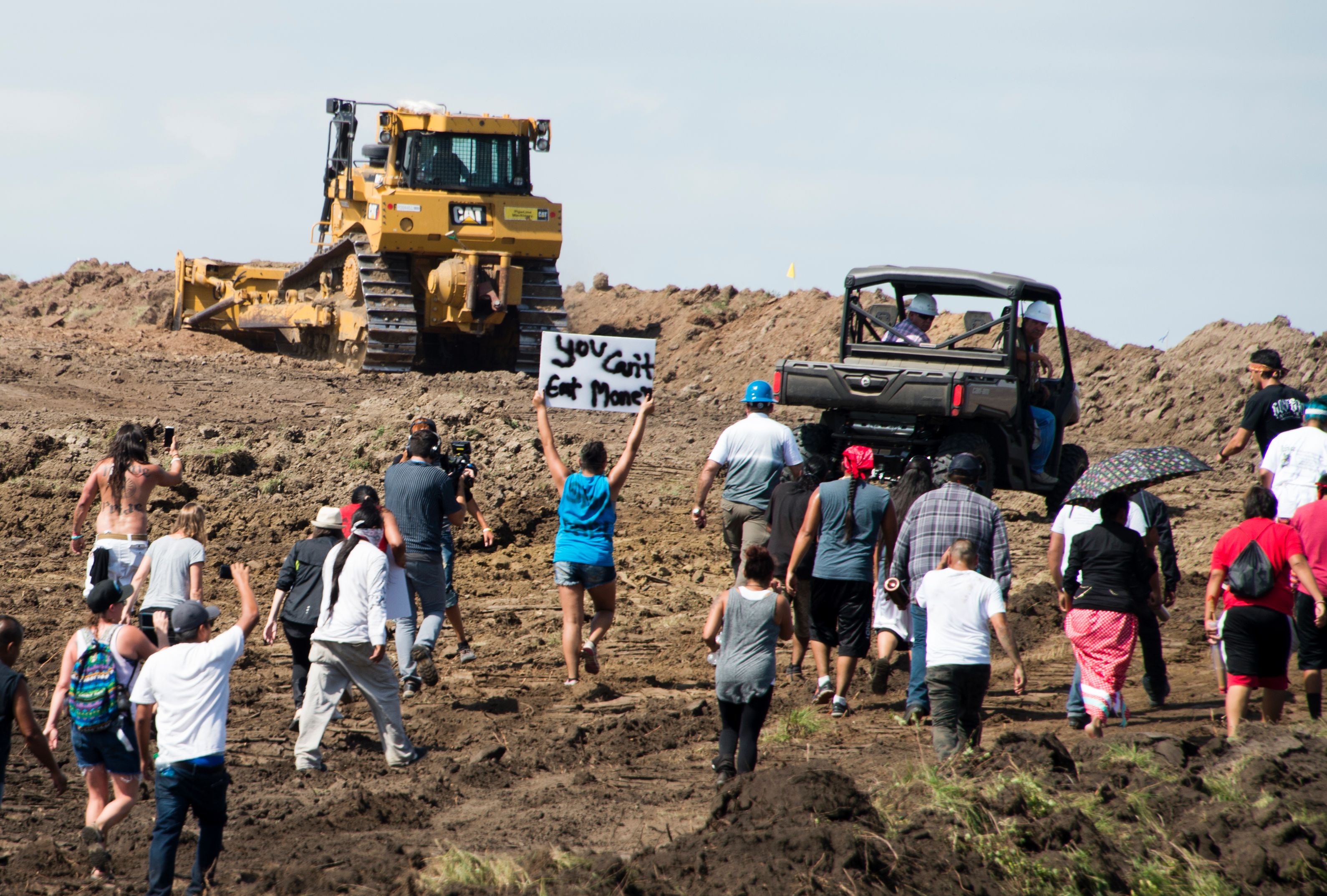 Native American protesters and their supporters are confronted by security during a demonstration against work being done for the Dakota Access Pipeline on September 3, 2016. CREDIT: ROBYN BECK/AFP/Getty Images
