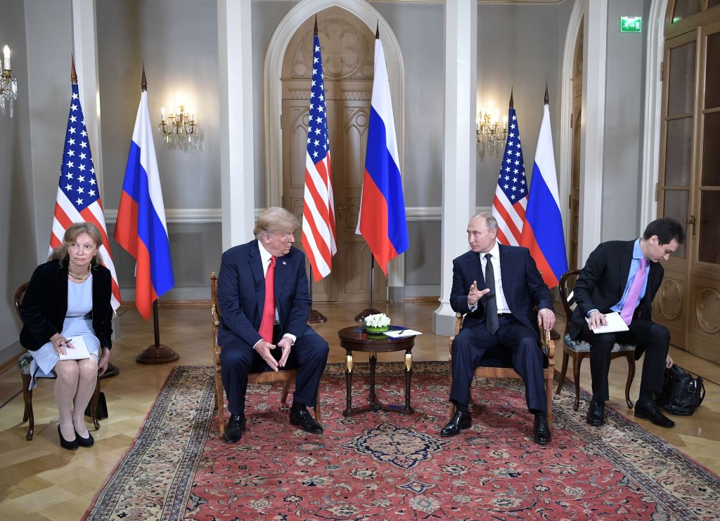 TRUMP and PUTIN, WITH TRUMP'S TRANSLATOR AT THE FAR LEFT OF THIS PHOTO. (CREDIT: Alexey NIKOLSKY / Sputnik / AFP)