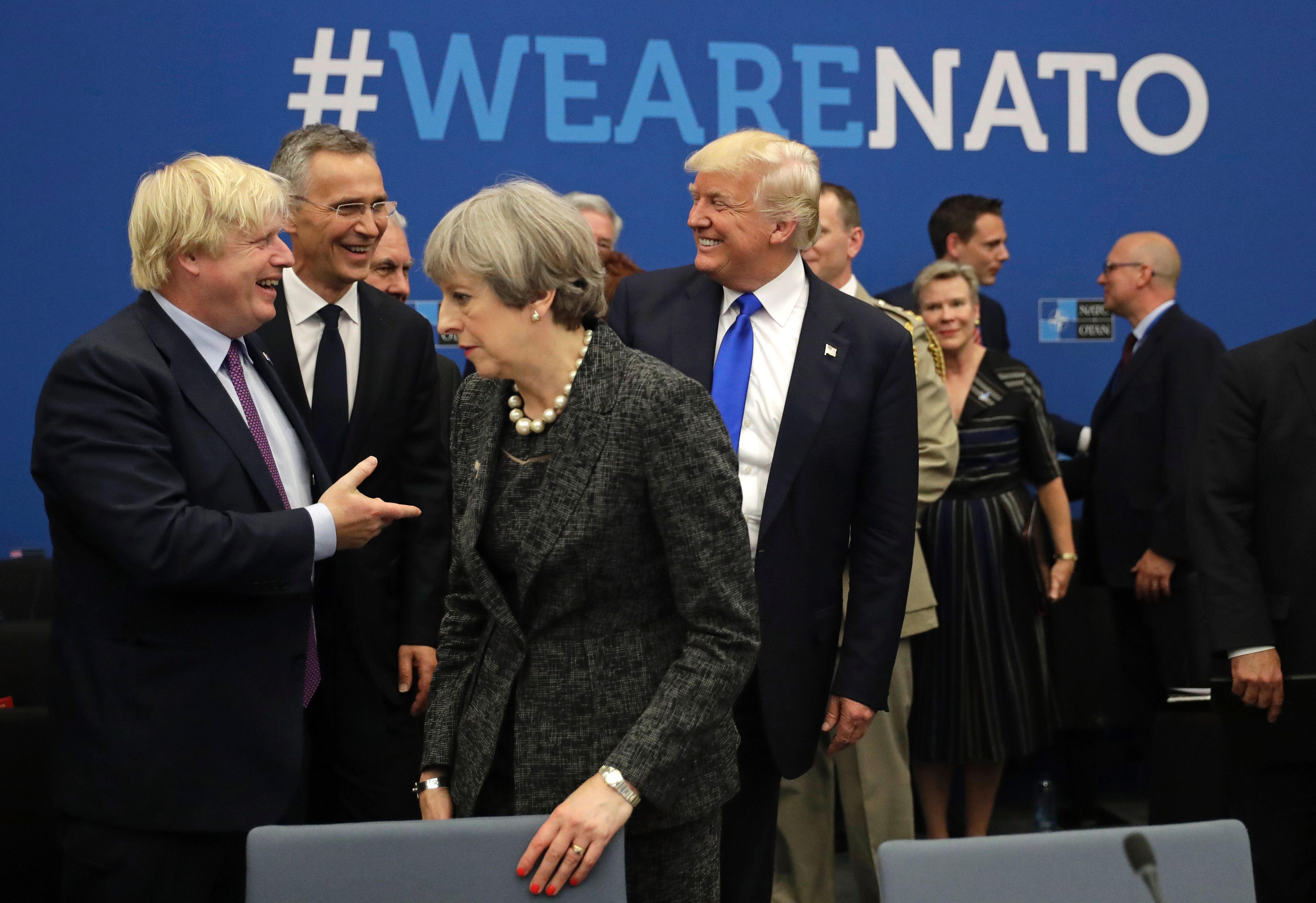 President Donald Trump laughs while speaking to NATO Secretary General Jens Stoltenberg and British Foreign Minister Boris Johnson as Britain's Prime Minister Theresa May passes at the May 2017 NATO summit. (CREDIT: Matt Dunham/AFP/Getty Images)