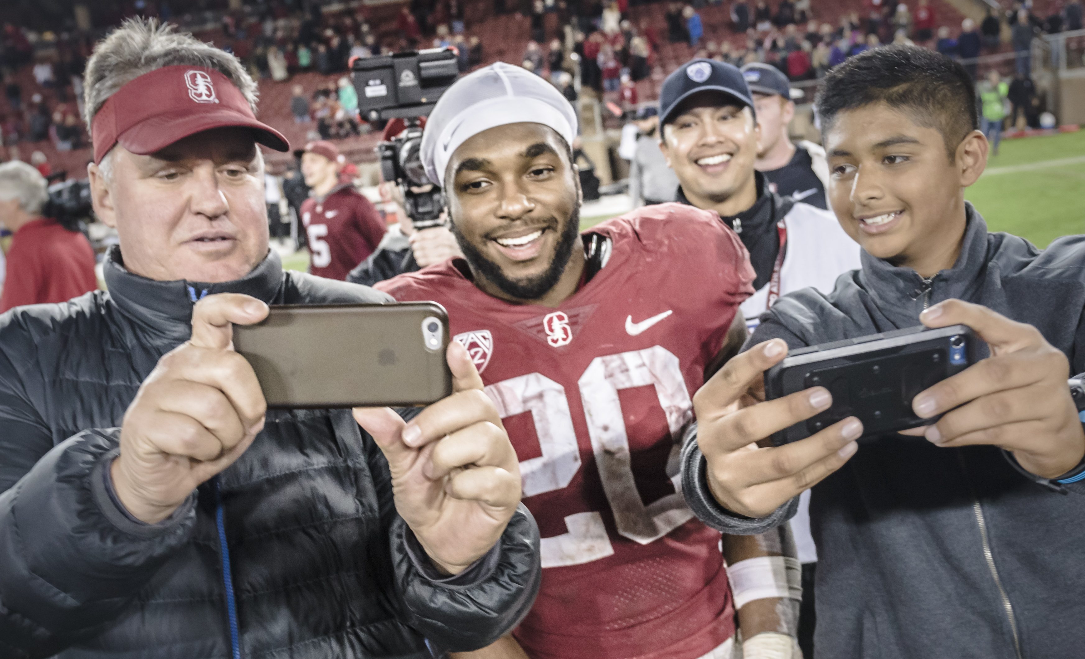 PALO ALTO, CA - NOVEMBER 10: Bryce Love #20 of the Stanford Cardinal poses with fans after an NCAA Pac-12 football game against the University of Washington Huskies on November 10, 2017 at Stanford Stadium in Palo Alto, California. (Photo by David Madison/Getty Images)