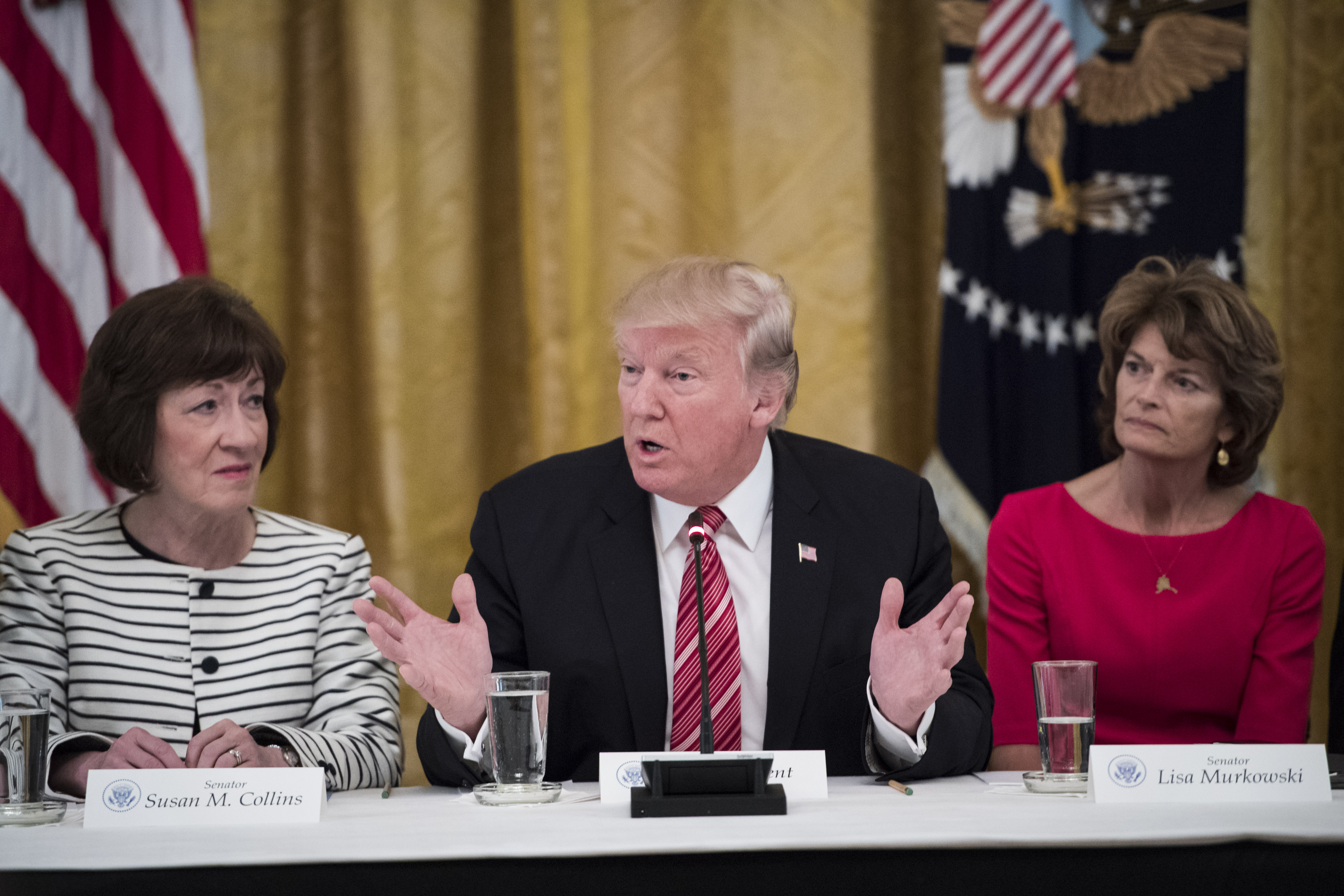 WASHINGTON, DC - JUNE 27: President Donald Trump, center, speaks as he meets with Republican senators about health care in the East Room of the White House of the White House in Washington, DC on Tuesday, June 27, 2017. Seated with him are Sen. Susan Collins, R-Maine, left, and Sen. Lisa Murkowski, R-Alaska, right, (Photo by Jabin Botsford/The Washington Post via Getty Images)