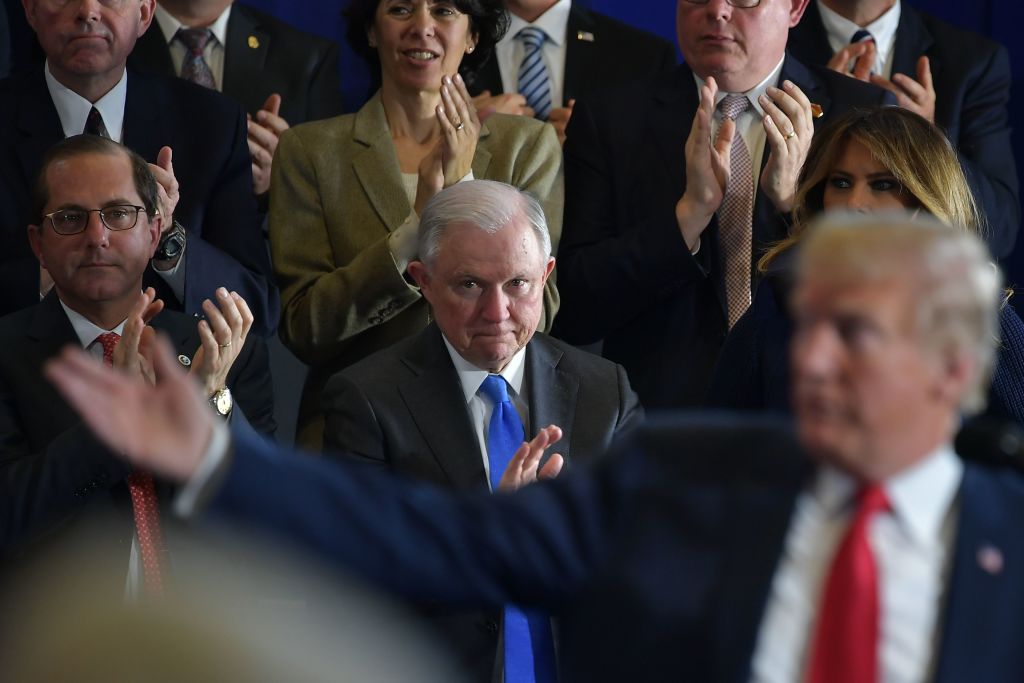 Attorney General Jeff Sessions applauds as US President Donald Trump gives a speech in March. CREDIT: MANDEL NGAN/AFP/Getty Images