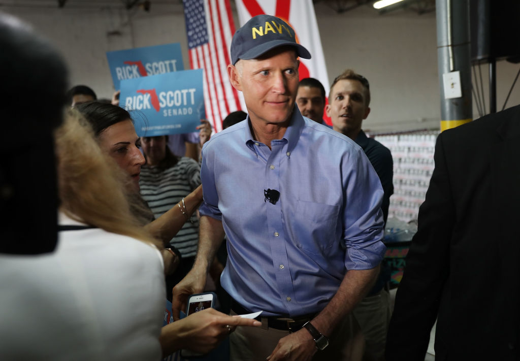 Florida Governor Rick Scott greets people as he holds a Senate campaign rally at the Interstate Beverage Corp. on April 10, 2018 in Hialeah, Florida. CREDIT: Joe Raedle/Getty Images