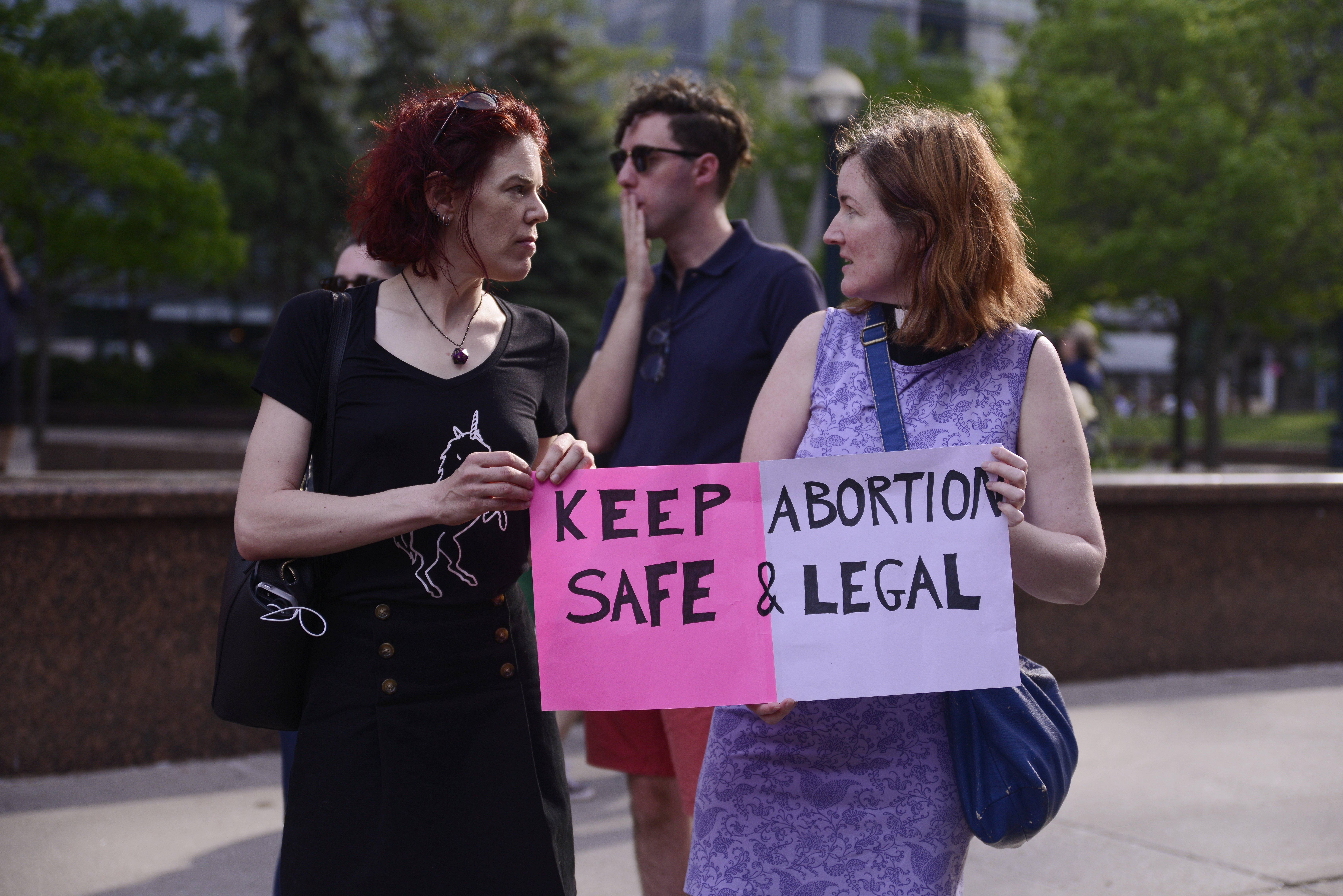 Supporters with signs asking for abortion to be safe and legal during in Toronto, Canada, on May 27, 2018. CREDIT: Arindam Shivaani/NurPhoto via Getty Images.