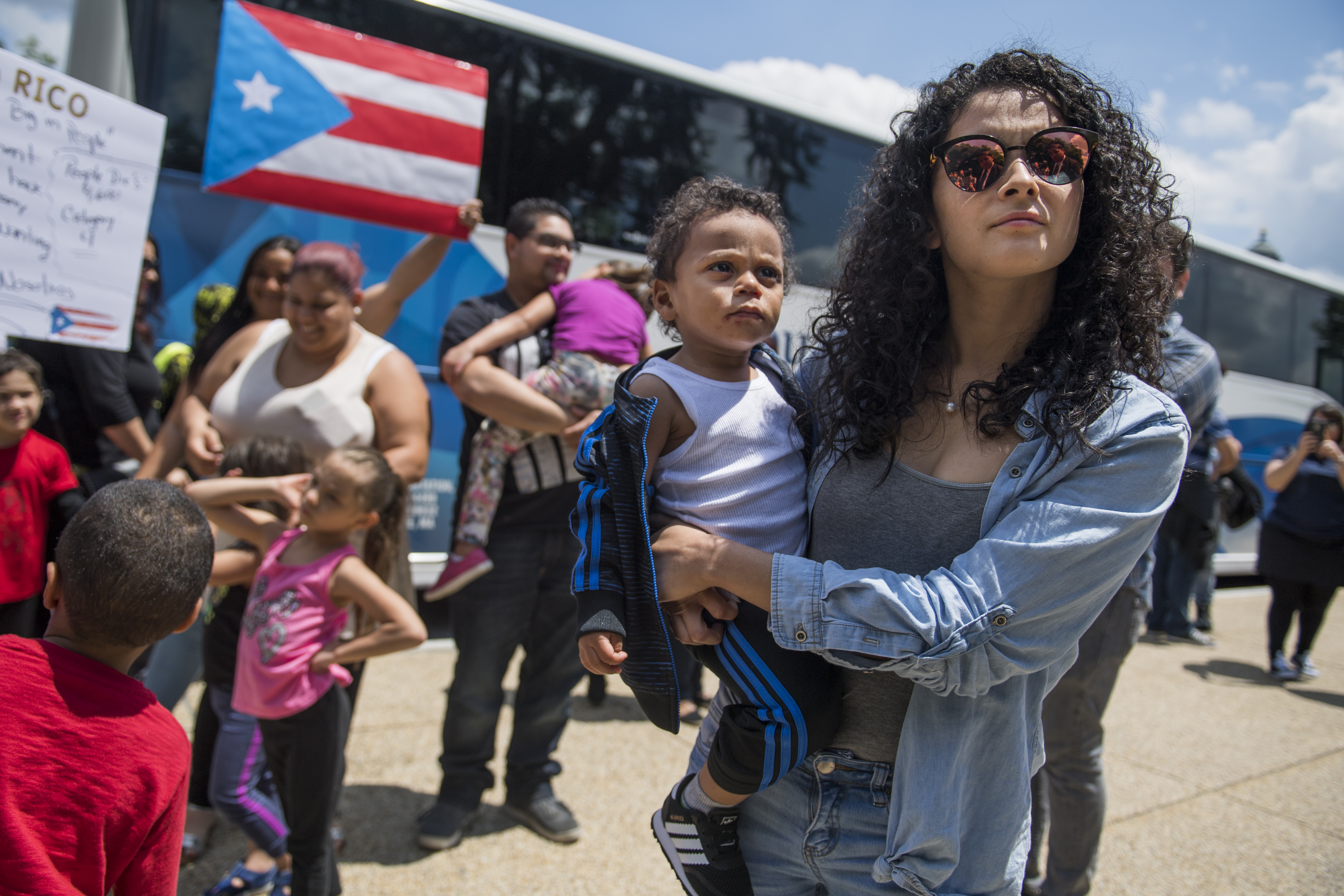 Analee Dalmau, and her son Mathais, 16 months, along with other Puerto Ricans who were displaced by Hurricane Maria, arrive in buses from western Massachusetts on First St., NE, on June 6, 2018. They came to urge members of Congress to enact the Disaster Housing Assistance Program (DHAP) because FEMA has not done so. (Photo By Tom Williams/CQ Roll Call)