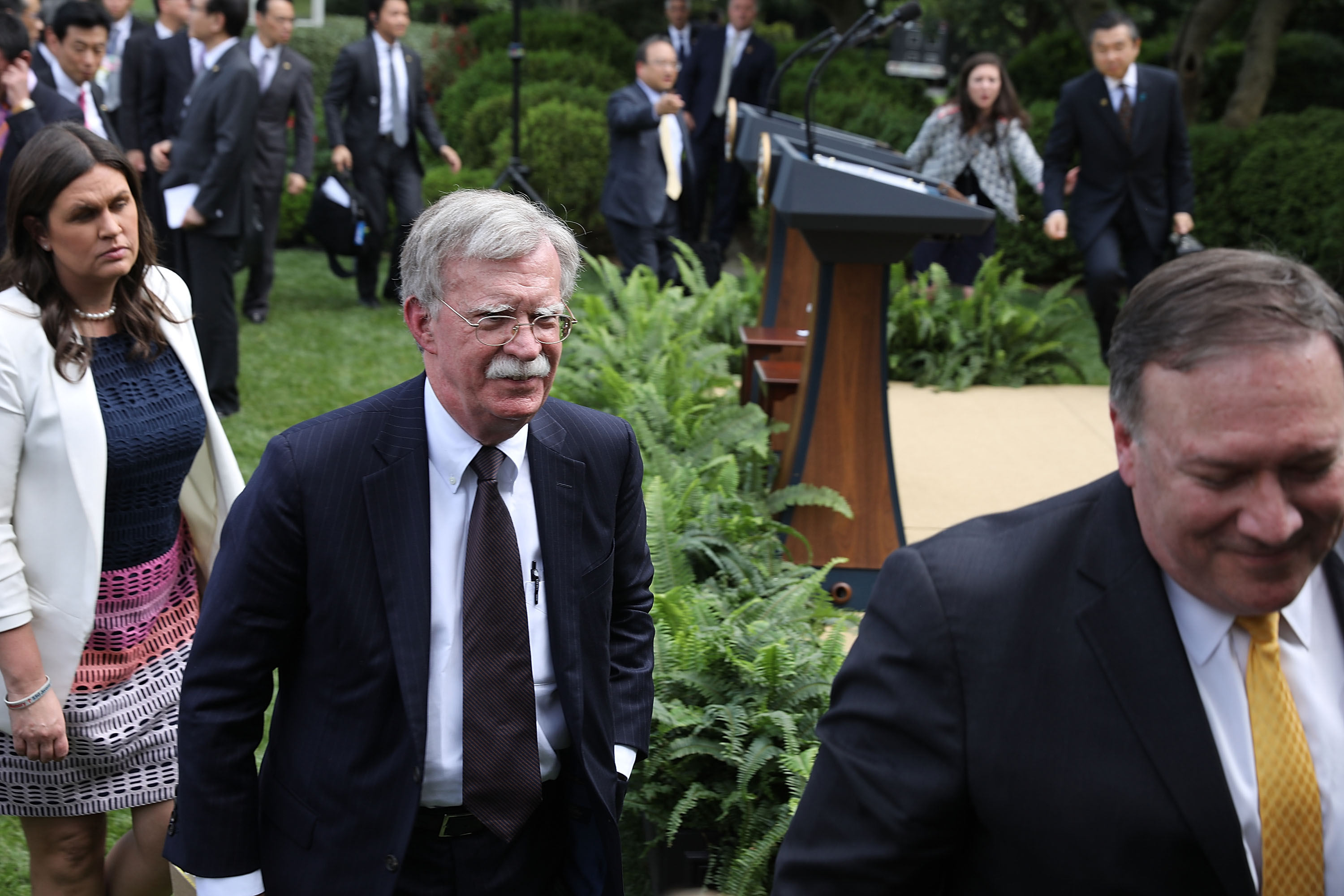 White House Press Secretary Sarah Huckabee Sanders, National Security Advisor John Bolton and U.S. Secretary of State Mike Pompeo leave the Rose Garden. CREDIT: Chip Somodevilla/Getty Images