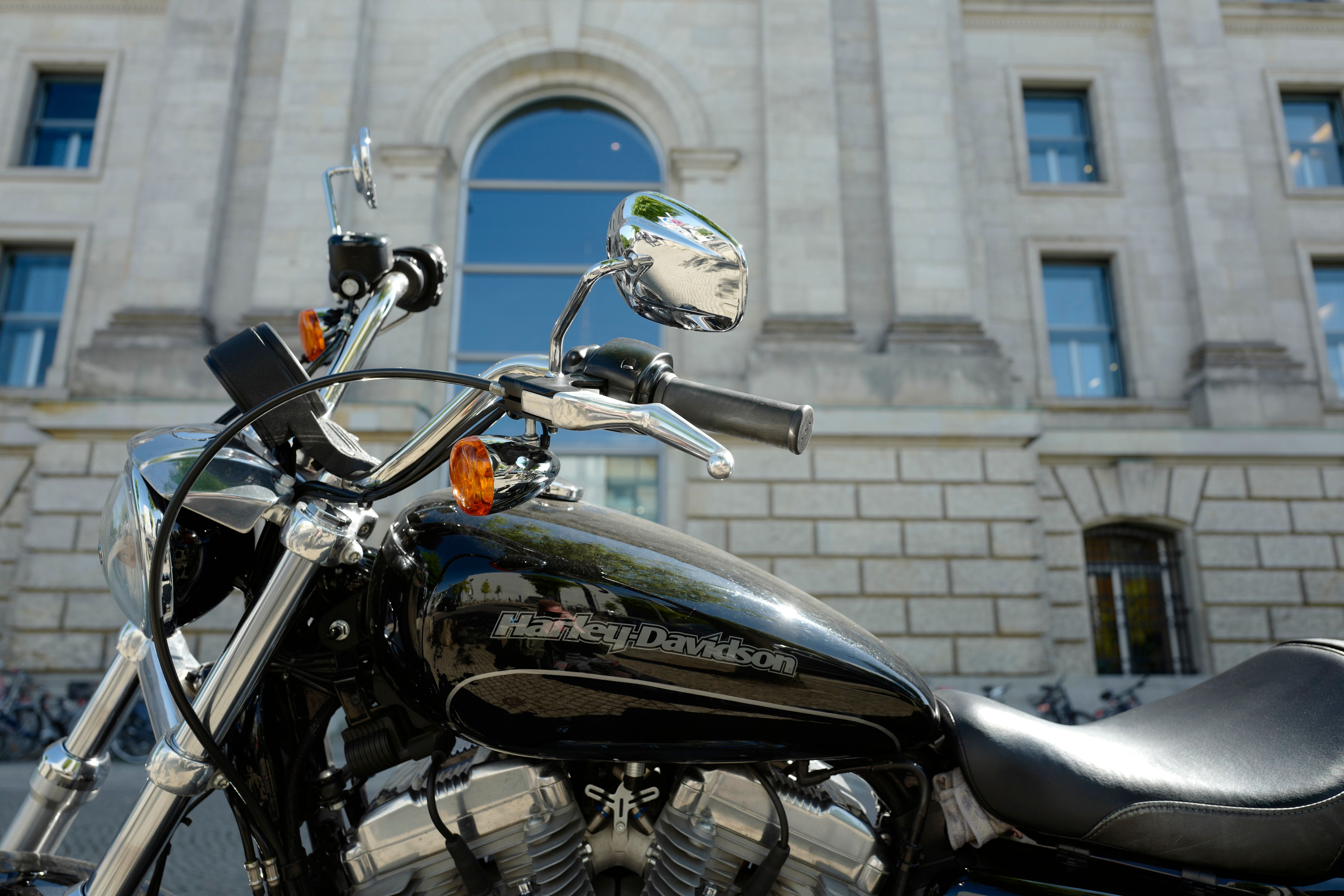 A Harley-Davidson motorbike parked in front of the Reichstag building which houses Germany's Bundestag lower house of parliament. - President Donald Trump on June 26, 2018 renewed his attacks on Harley-Davidson, accusing the US motorcycle manufacturer of using the trade war as an "excuse" to move production for the European market out of the United States. (Photo by John MACDOUGALL / AFP) (Photo credit should read JOHN MACDOUGALL/AFP/Getty Images)