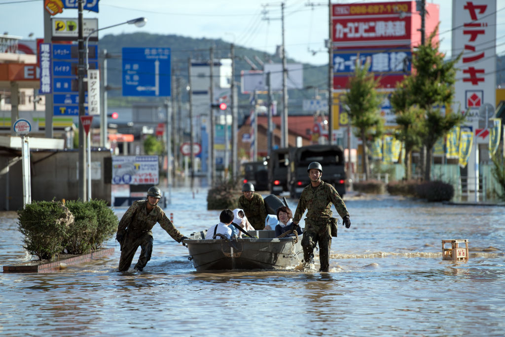 OKAYAMA, JAPAN - JULY 08: Soldiers ferry people to safety following heavy flooding, on July 8, 2018 in Kurashiki near Okayama, Japan. CREDIT: Carl Court/Getty Images