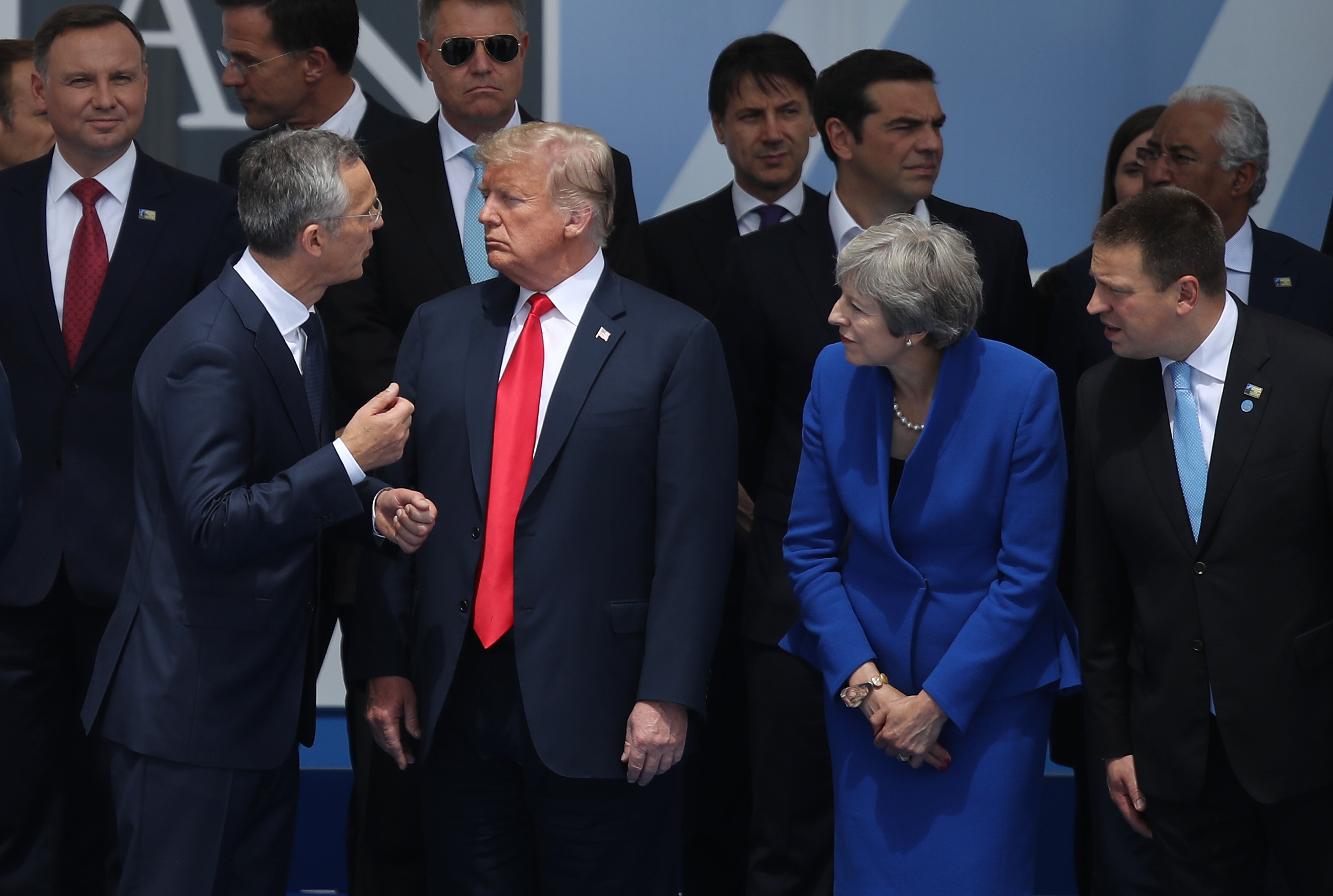 NATO Secretary General Jens Stoltenberg speaks to President Donald Trump and British Prime Minister Theresa May attend the opening ceremony at the 2018 NATO Summit at NATO headquarters on July 11, 2018 in Brussels, Belgium. CREDIT: Sean Gallup/Getty Images.