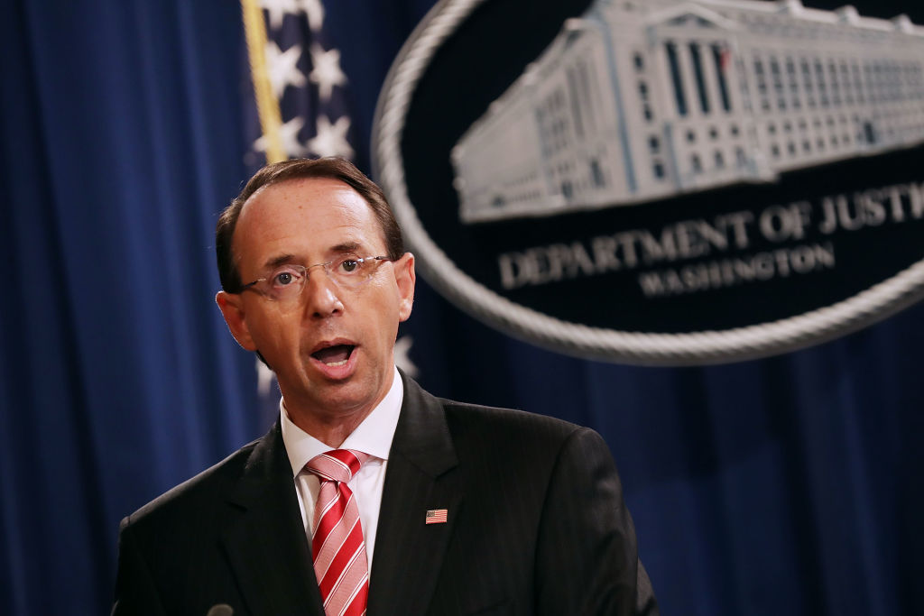 U.S. Deputy Attorney General Rod Rosenstein holds a news conference at the Department of Justice July 13, 2018 in Washington, D.C., to announce indictments against 12 Russian intelligence agents for hacking computers used by the Democratic National Committee, the Hillary Clinton campaign, the Democratic Congressional Campaign Committee and other organizations. (Photo credit: Chip Somodevilla/Getty Images)