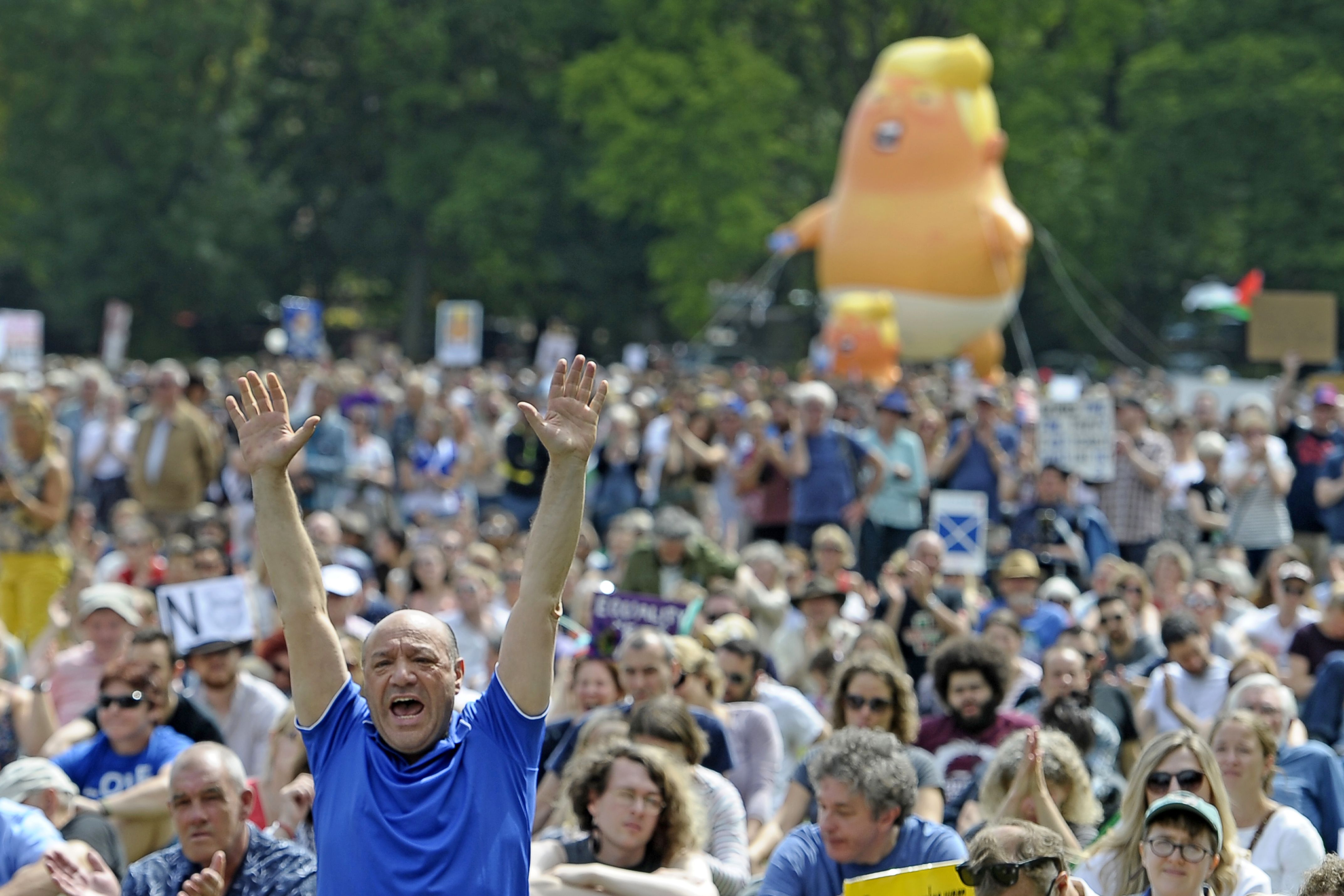 A giant balloon depicting US President Donald Trump as an orange baby is launched as protesters gather in the Meadows, after taking part in the Scotland United Against Trump march through the streets of Edinburgh, Scotland on July 14, 2018, on the third day of US President Donald Trump's four-day UK visit. CREDIT: NEIL HANNA/AFP/Getty Images
