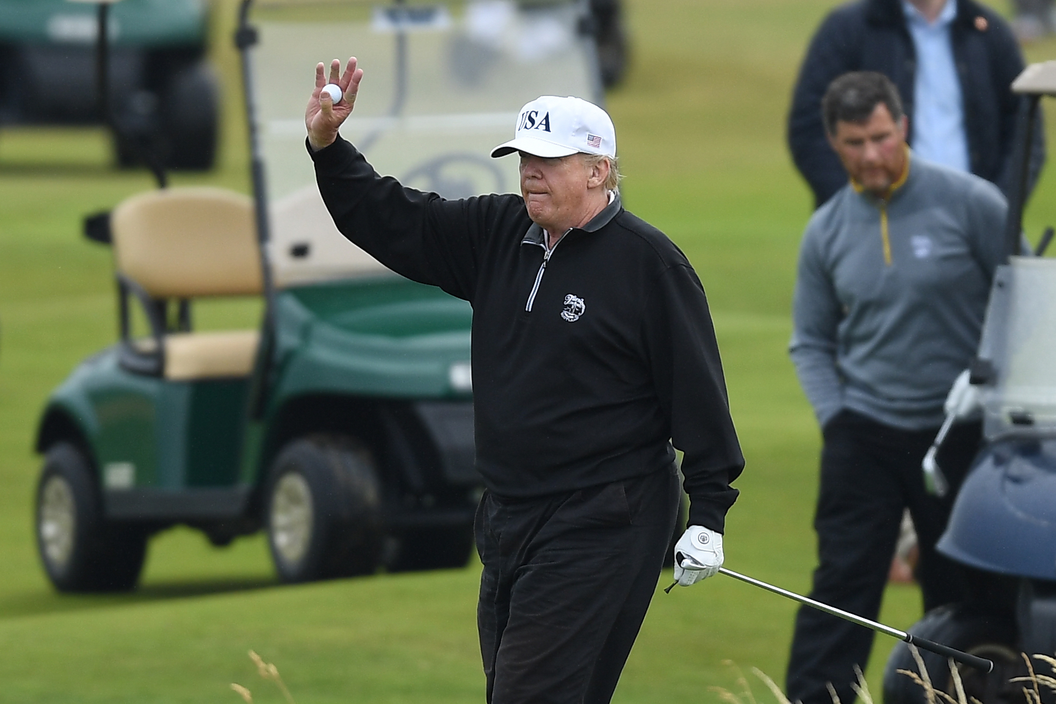 TURNBERRY, SCOTLAND - JULY 15: U.S. President Donald Trump waves whilst playing a round of golf at Trump Turnberry Luxury Collection Resort during the U.S. President's first official visit to the United Kingdom on July 15, 2018 in Turnberry, Scotland. (Credit: Leon Neal/Getty Images)