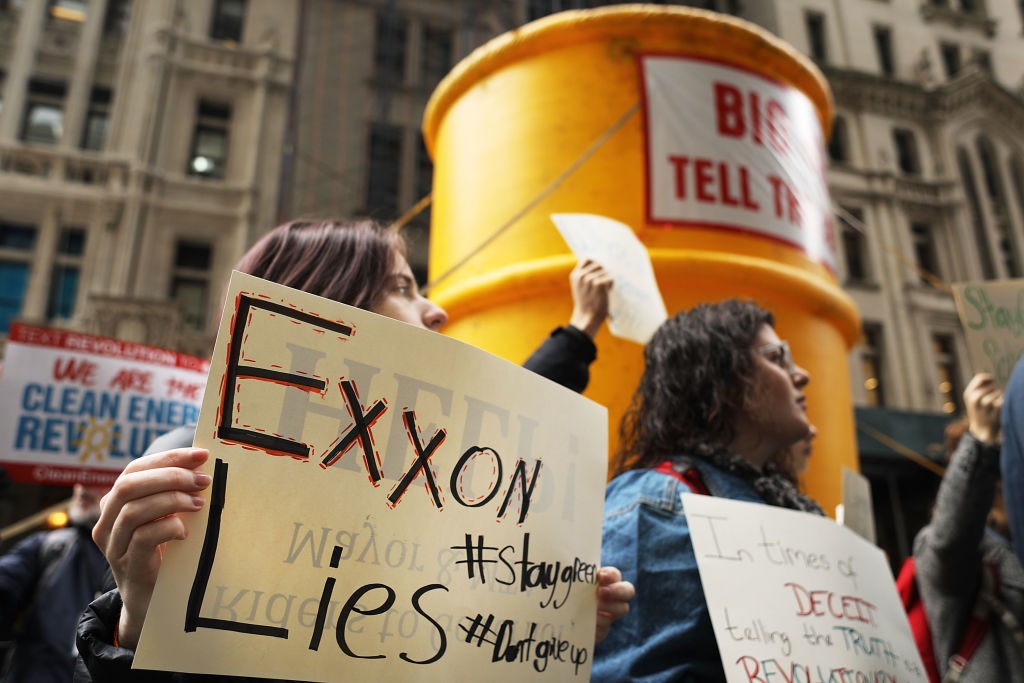Activists rally in New York City to support the state's investigation into whether oil giant Exxon covered up its knowledge about climate change, February 22, 2017. CREDIT: Spencer Platt/Getty Images