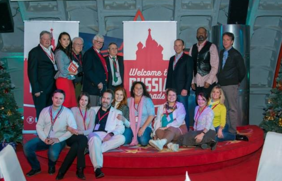 Clarke (second from the right in back) stands over Butina (fifth from the right in front).