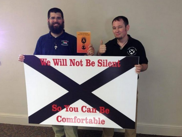 Matthew Heimbach (left) with the flag of the League of the South.