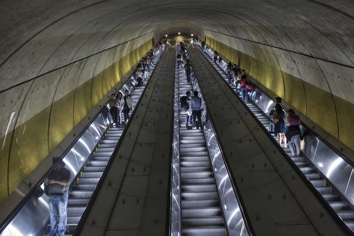 An escalator carries pedestrians up and down the deep underground metro on September, 17, 2017 in downtown Washington, D.C. (Photo Credit: Andrew Lichtenstein/Corbis)