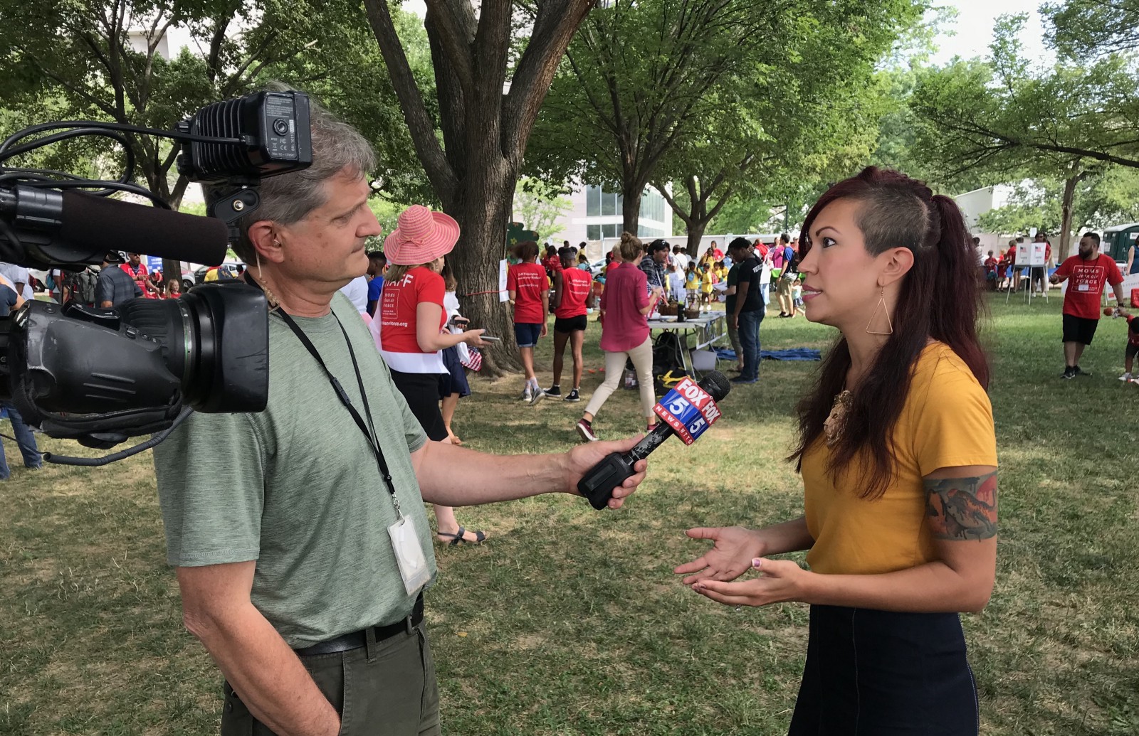 Kristin Mink speaking to a reporter at the rally. CREDIT: Nexus Media