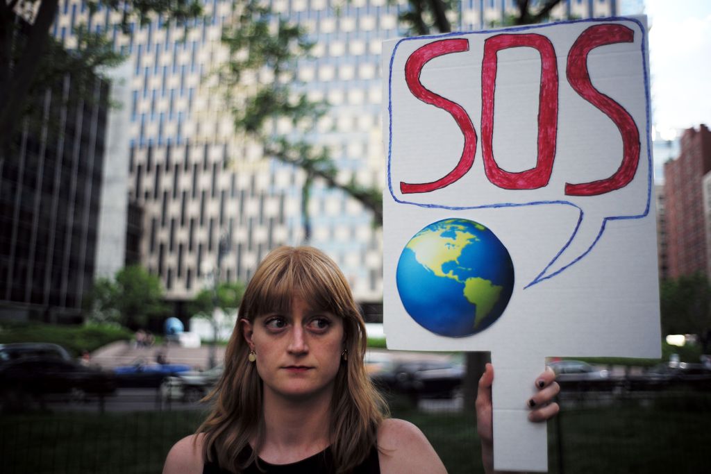 A woman displays a placard during a demonstration in New York on June 1, 2017, to protest US President Donald Trump's decision to pull out of the 195-nation Paris climate accord deal.
(Credit: JEWEL SAMAD/AFP/Getty Images)